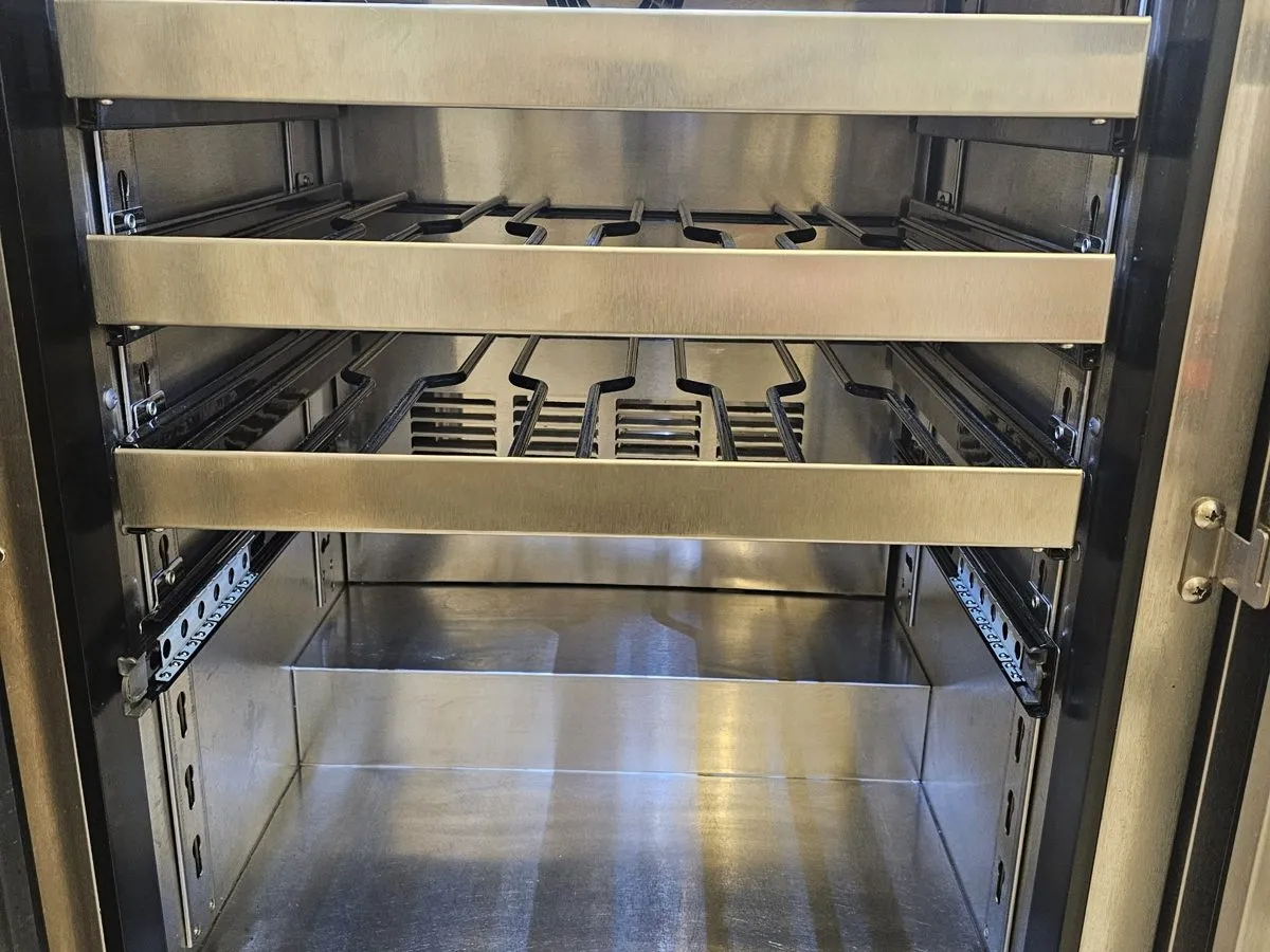 Stainless undercounter wine and beverage unit open for repair