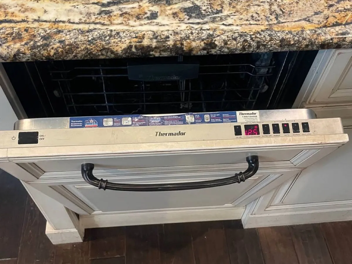 Thermador DWHD dishwasher open during service with the control panel visible