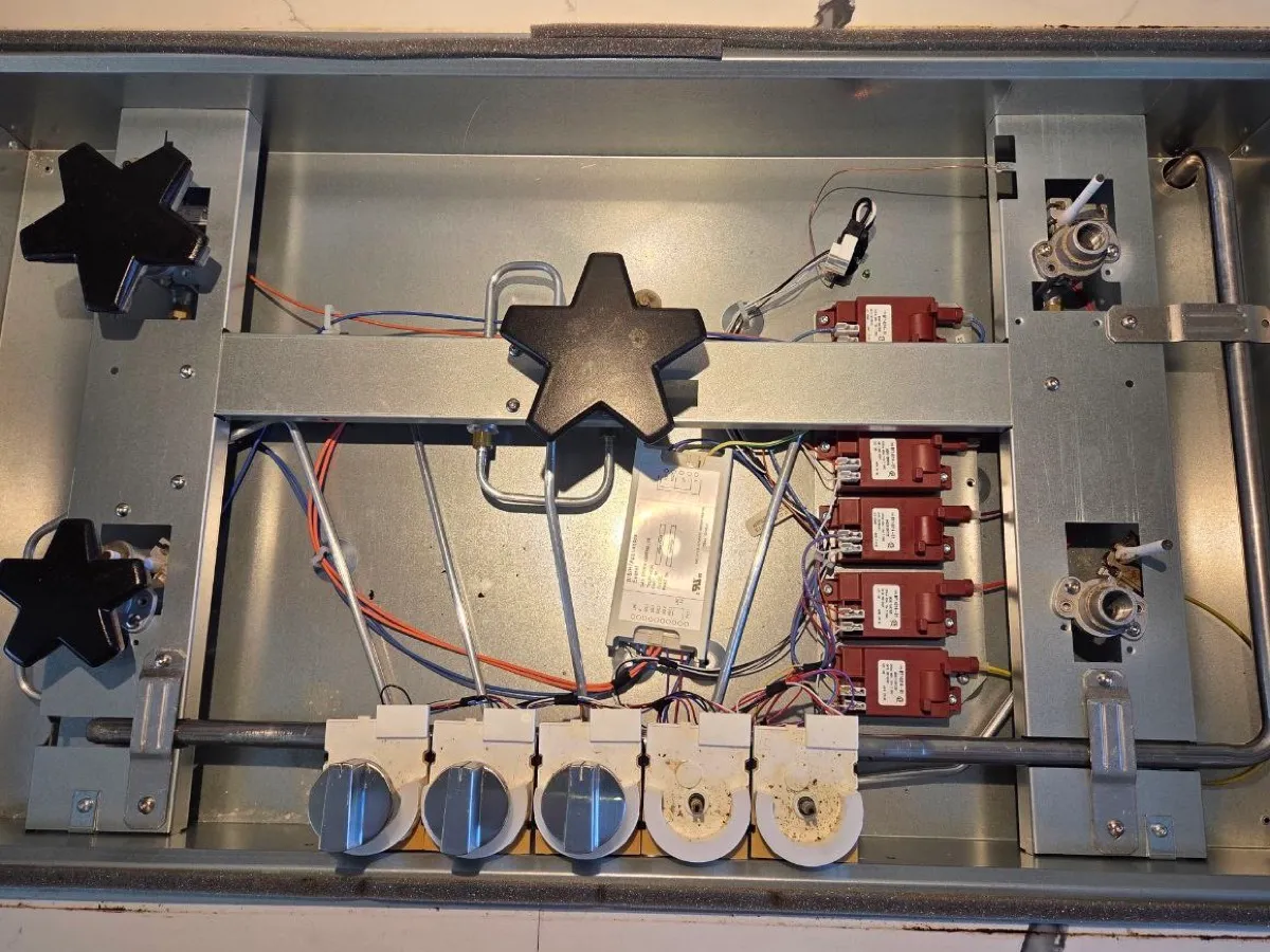 Underside of a Thermador gas rangetop with star burners and spark modules