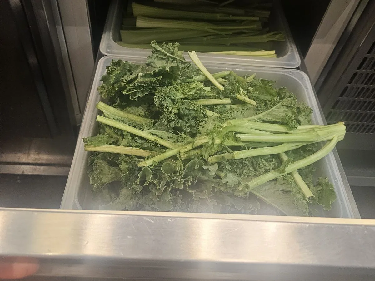 Refrigerated prep table drawer with fresh produce in an NYC commercial kitchen