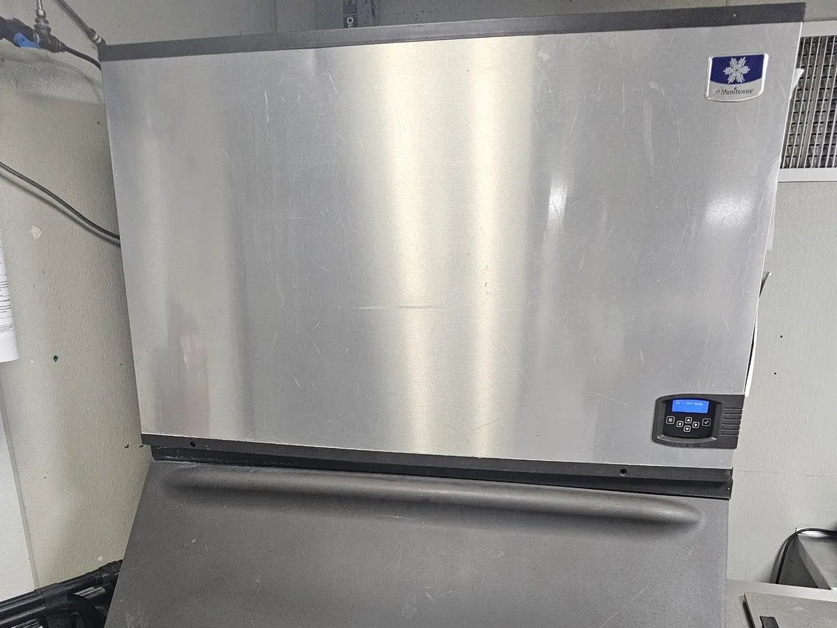 Manitowoc commercial ice machine head on a storage bin in an NYC restaurant
