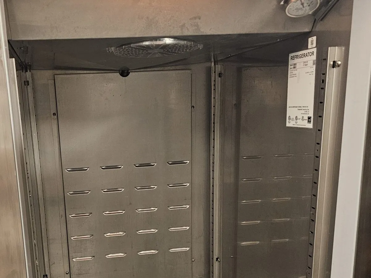 Stainless steel interior of an upright commercial refrigeration cabinet during service in NYC