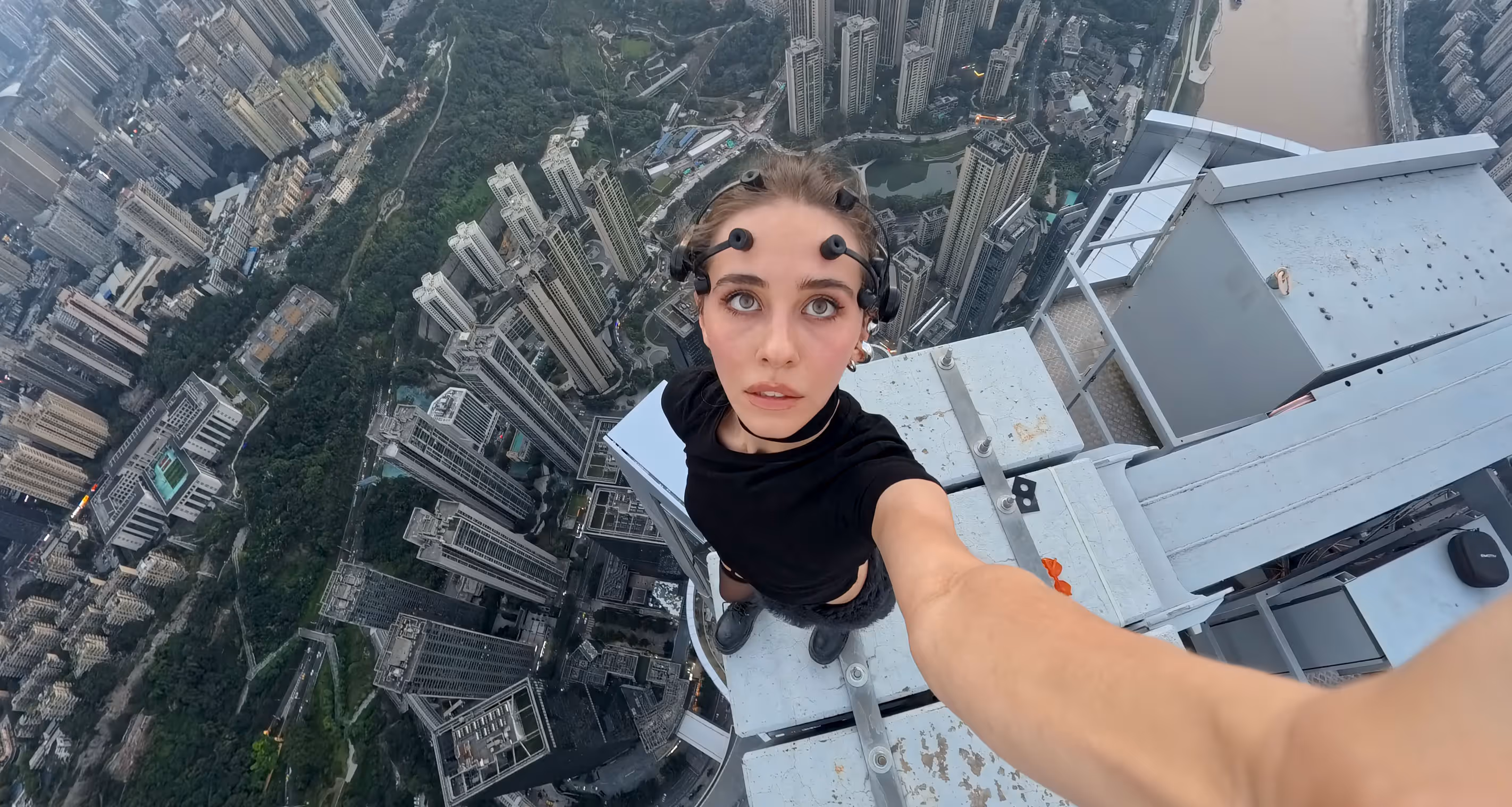 A woman on top of a building taking a selfie