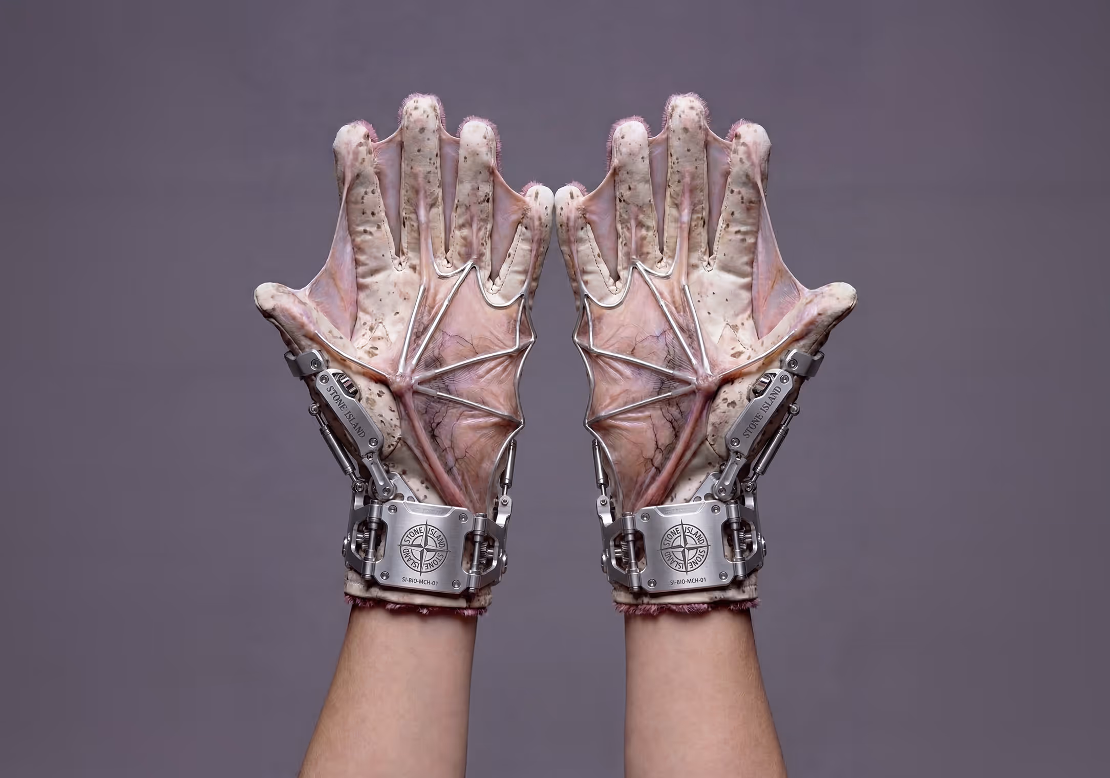 Hands that look like fish fins and metal gear on them with Stone Island Logo