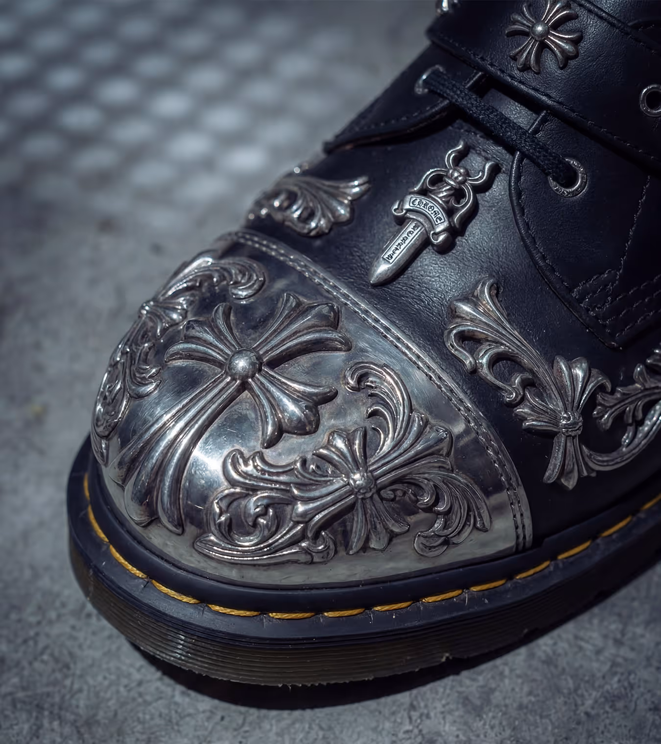 Dr Martens boots with Chrome Hearts toe metal cap detailing.