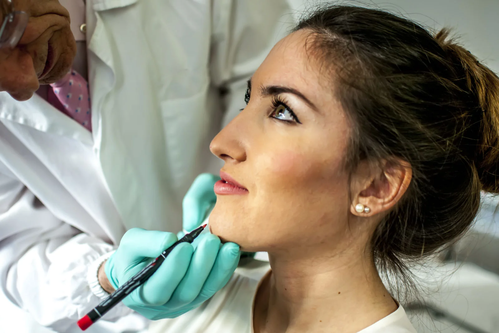 Surgeon marking a patient's jawline at Coastal Virginia Oral Surgery.