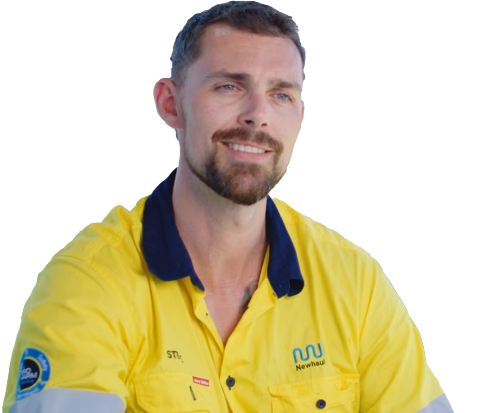 Man with short brown hair and beard wearing a yellow high-visibility shirt with Newhaul logo smiling.