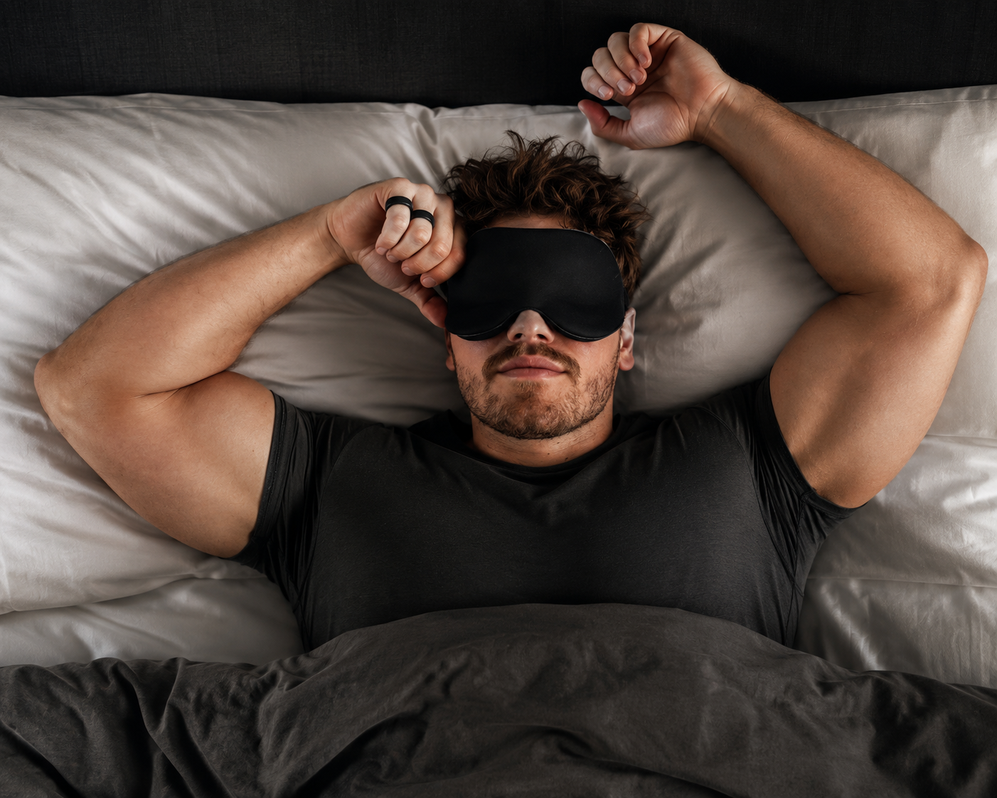 Person lifting a sleep mask off their face and smiling.