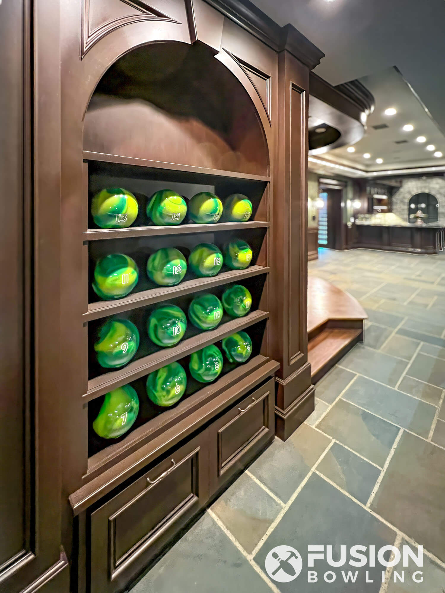 Custom green bowling balls in built-in custom shelving millwork.