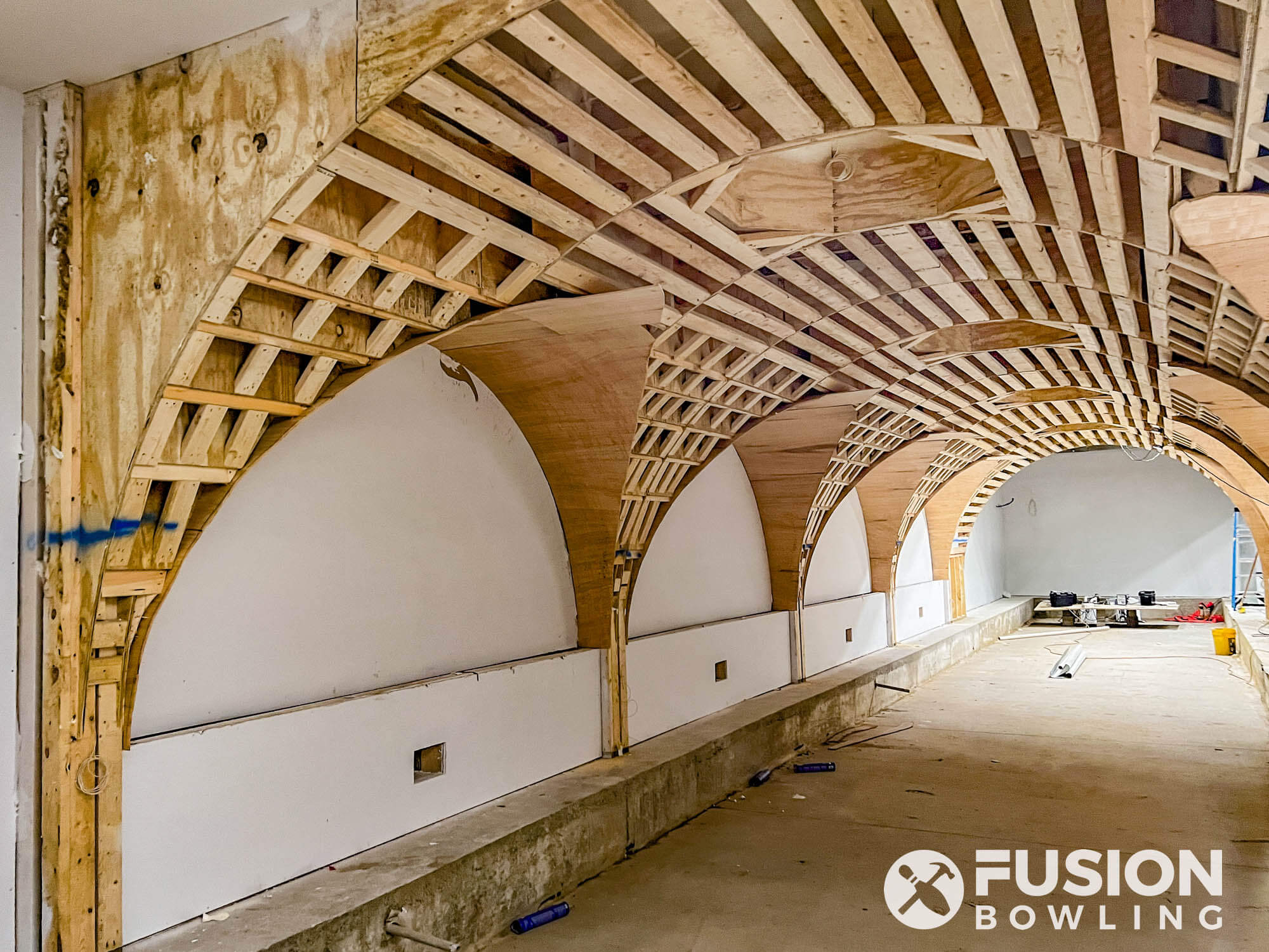 Framing for ceiling arches above a home bowling alley.