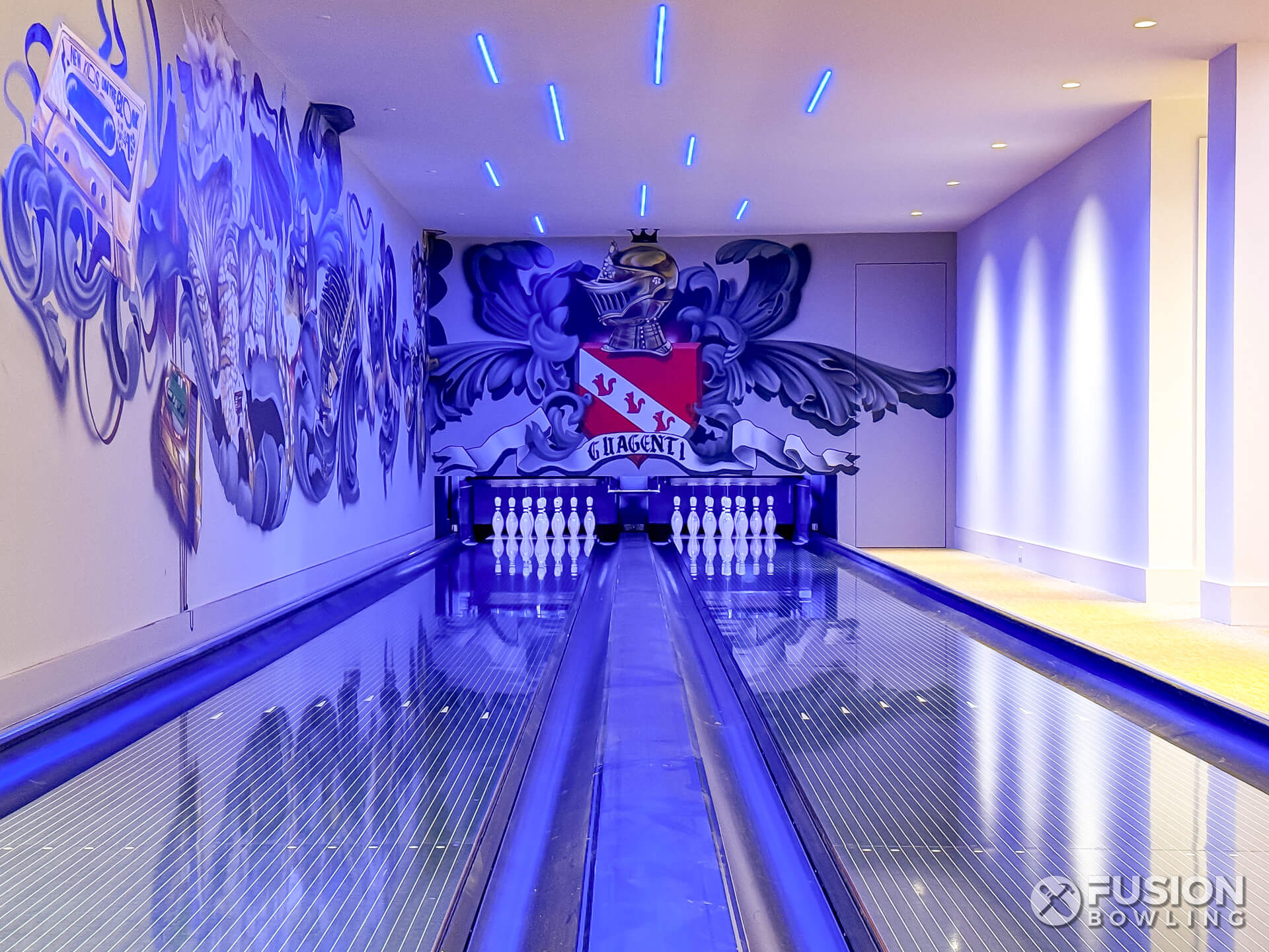 2 bowling lanes under UV black lighting.