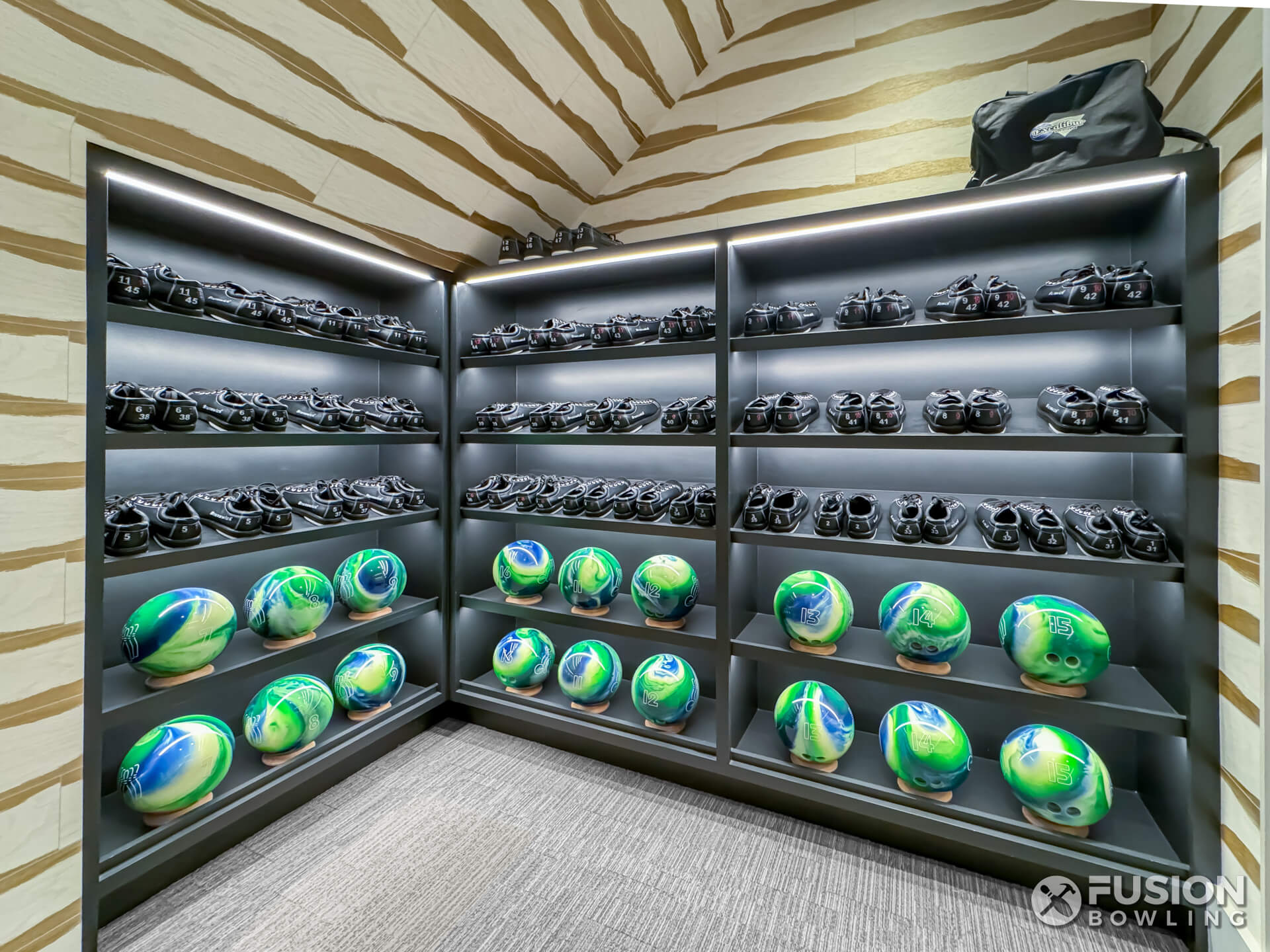 Built-in shelving for bowling shoes and green-blue bowling balls in a home.