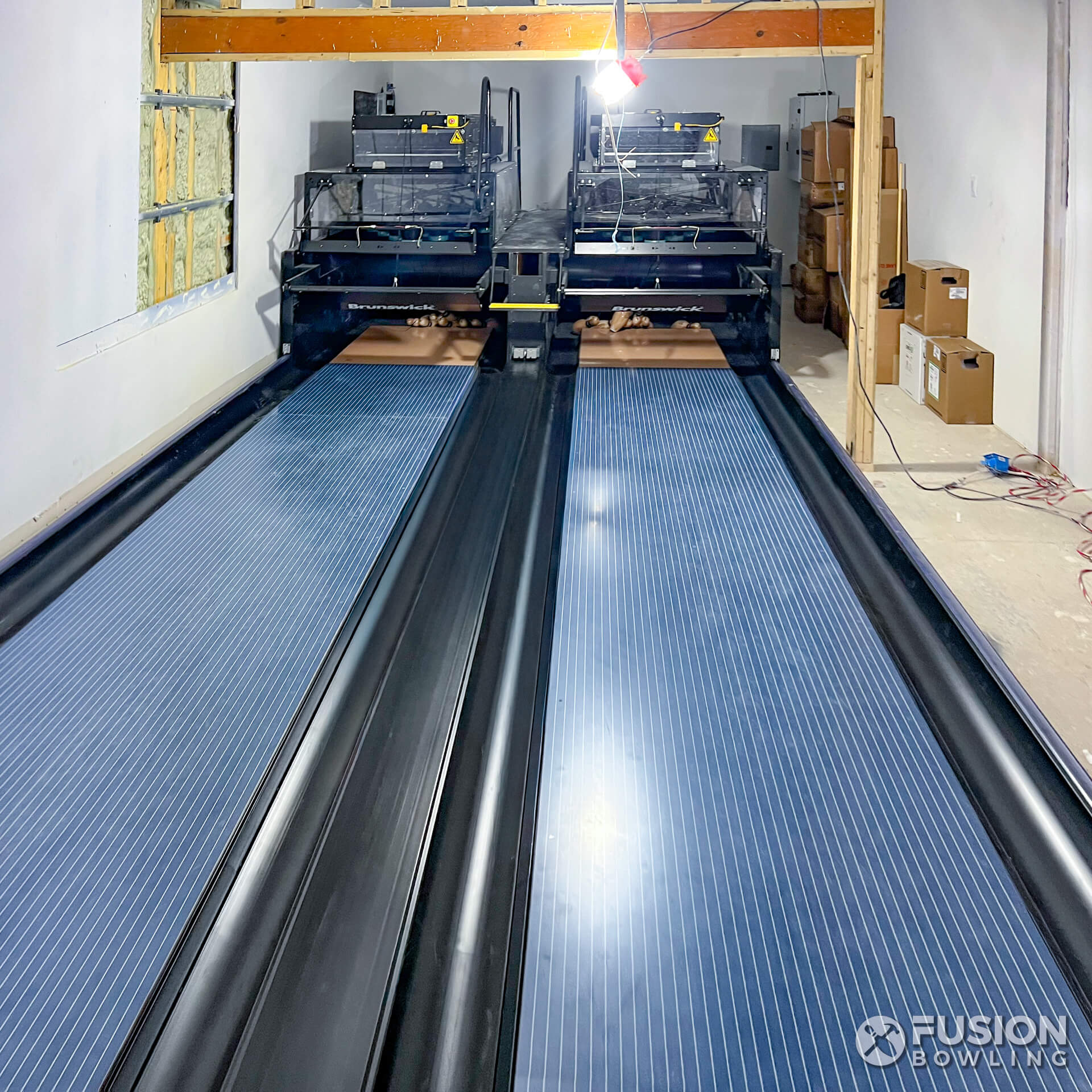 Custom home bowling alley with blue lanes.