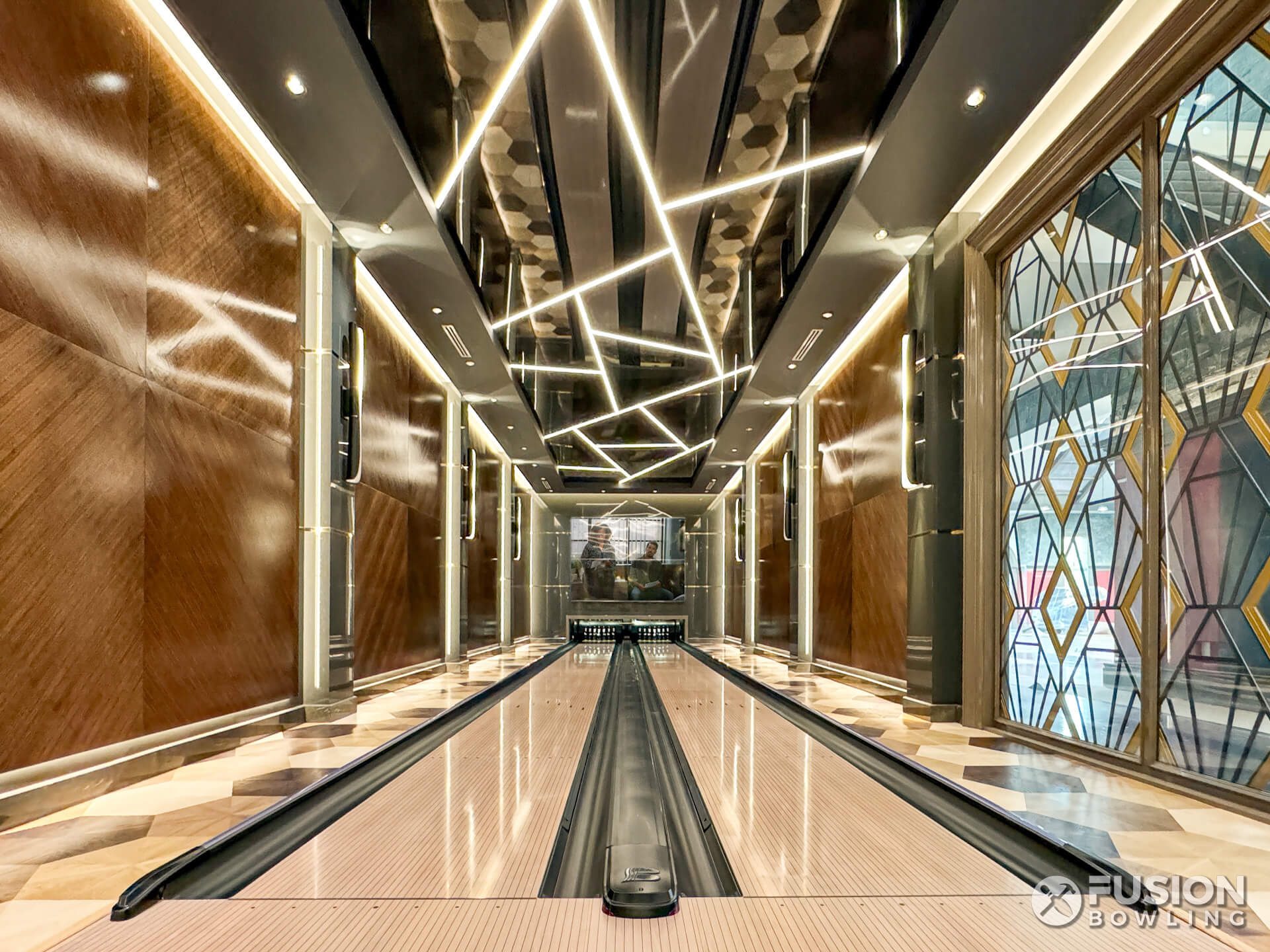 Dramatic art-deco inspired in-home bowling lanes by Fusion Bowling.
