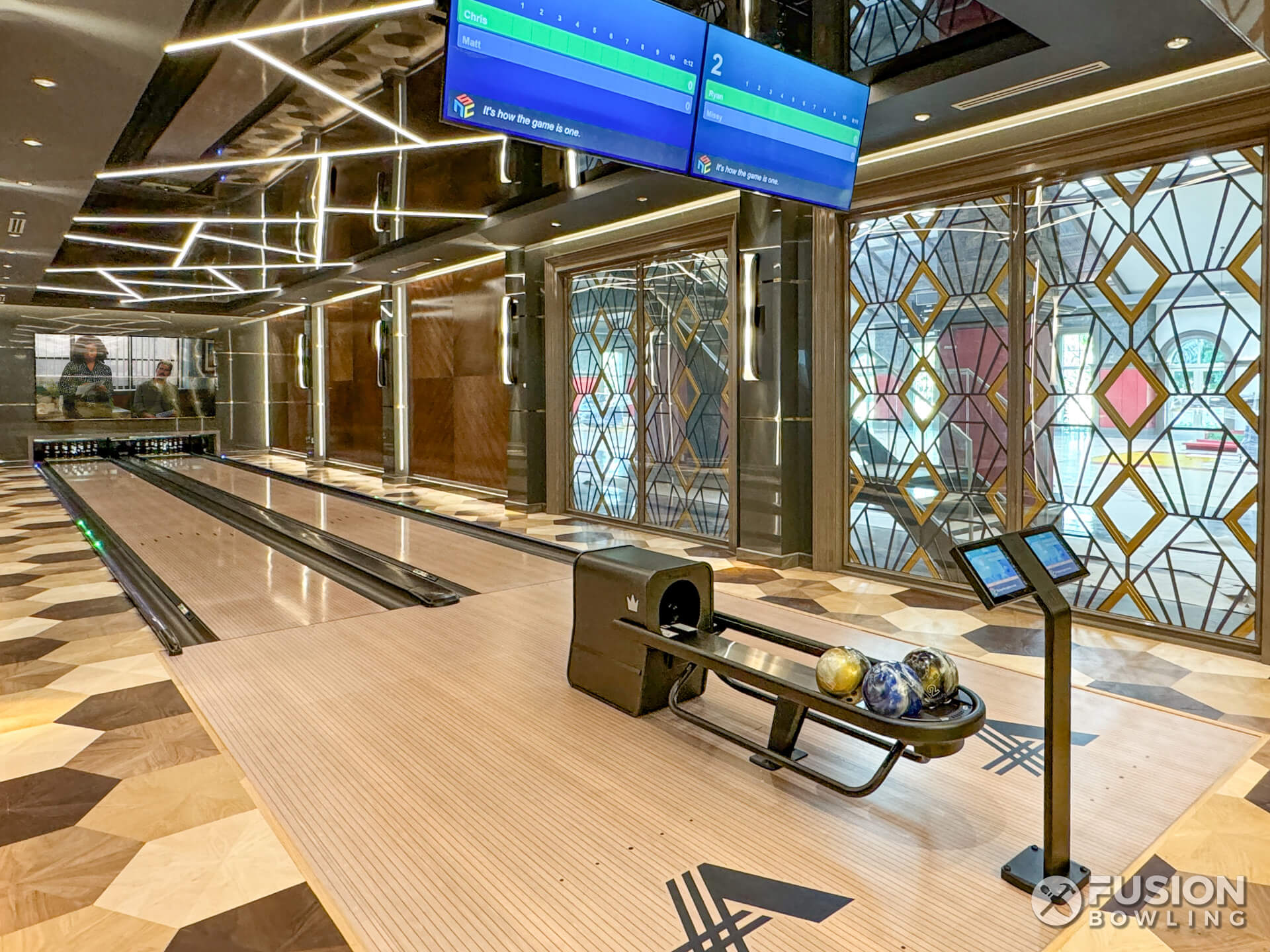 Private indoor bowling alley with glass wall in a home near Miami.