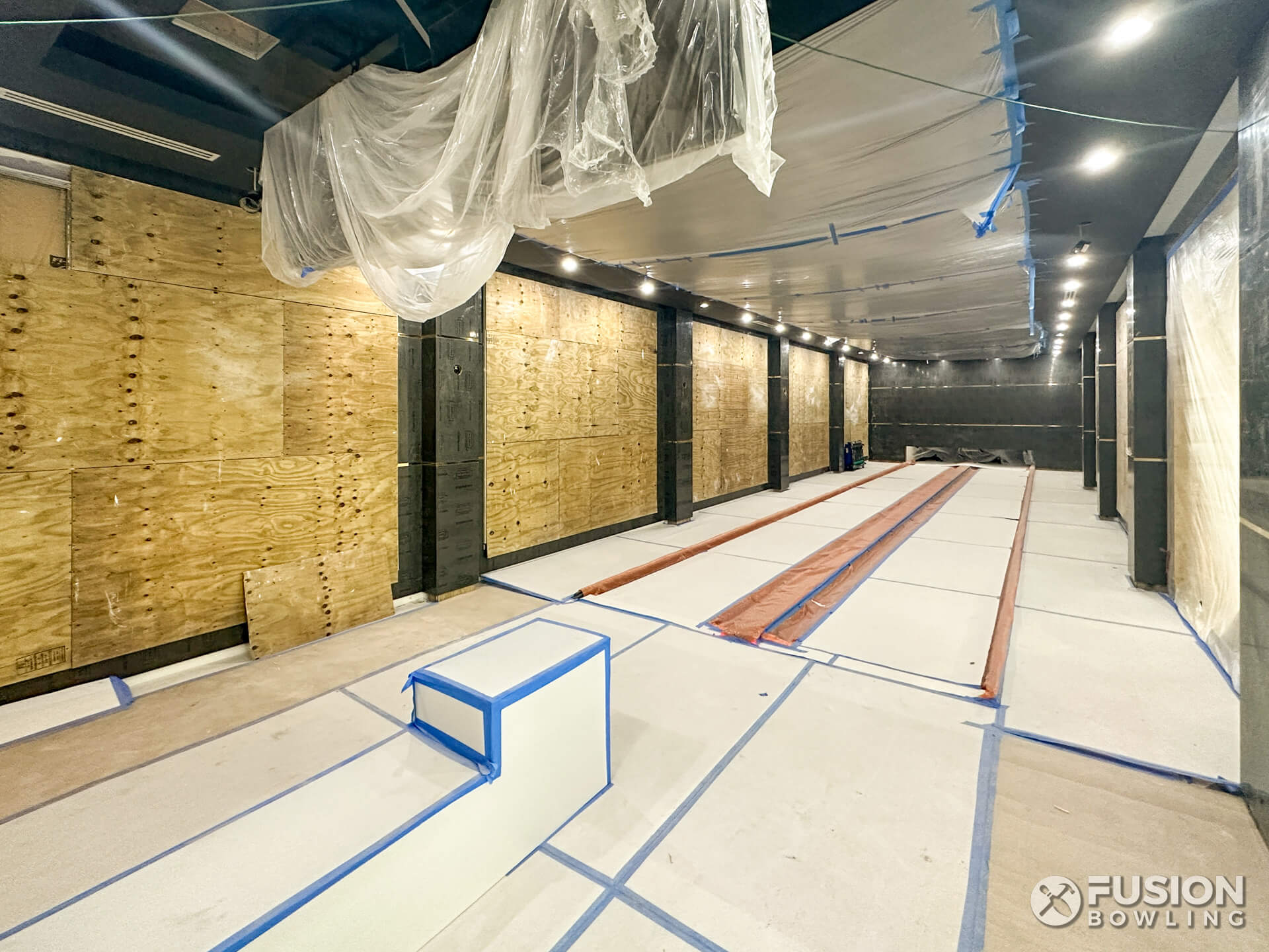 Bowling alley equipment protected while room is being finished.