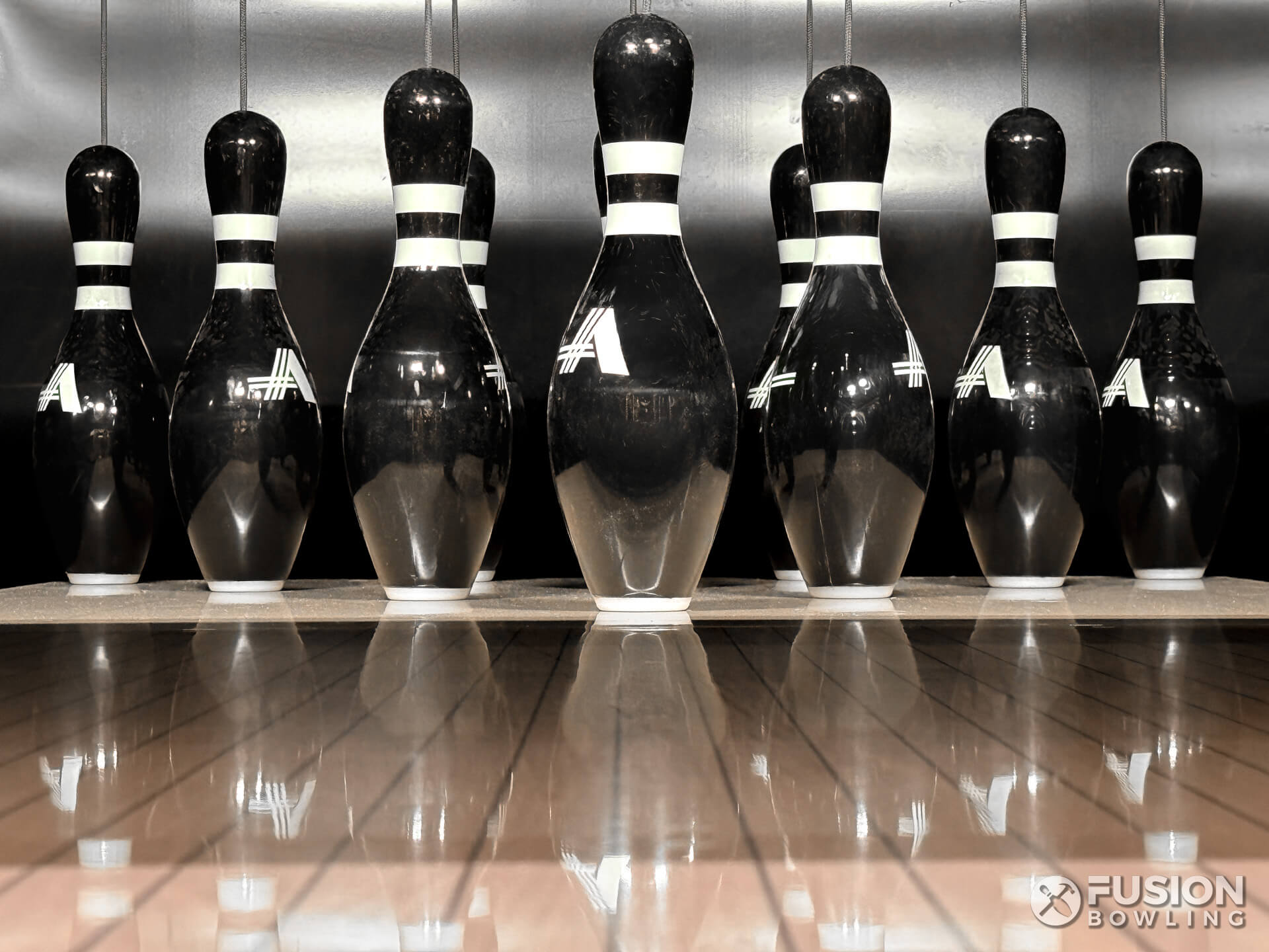 Custom black bowling pins with white stripes.