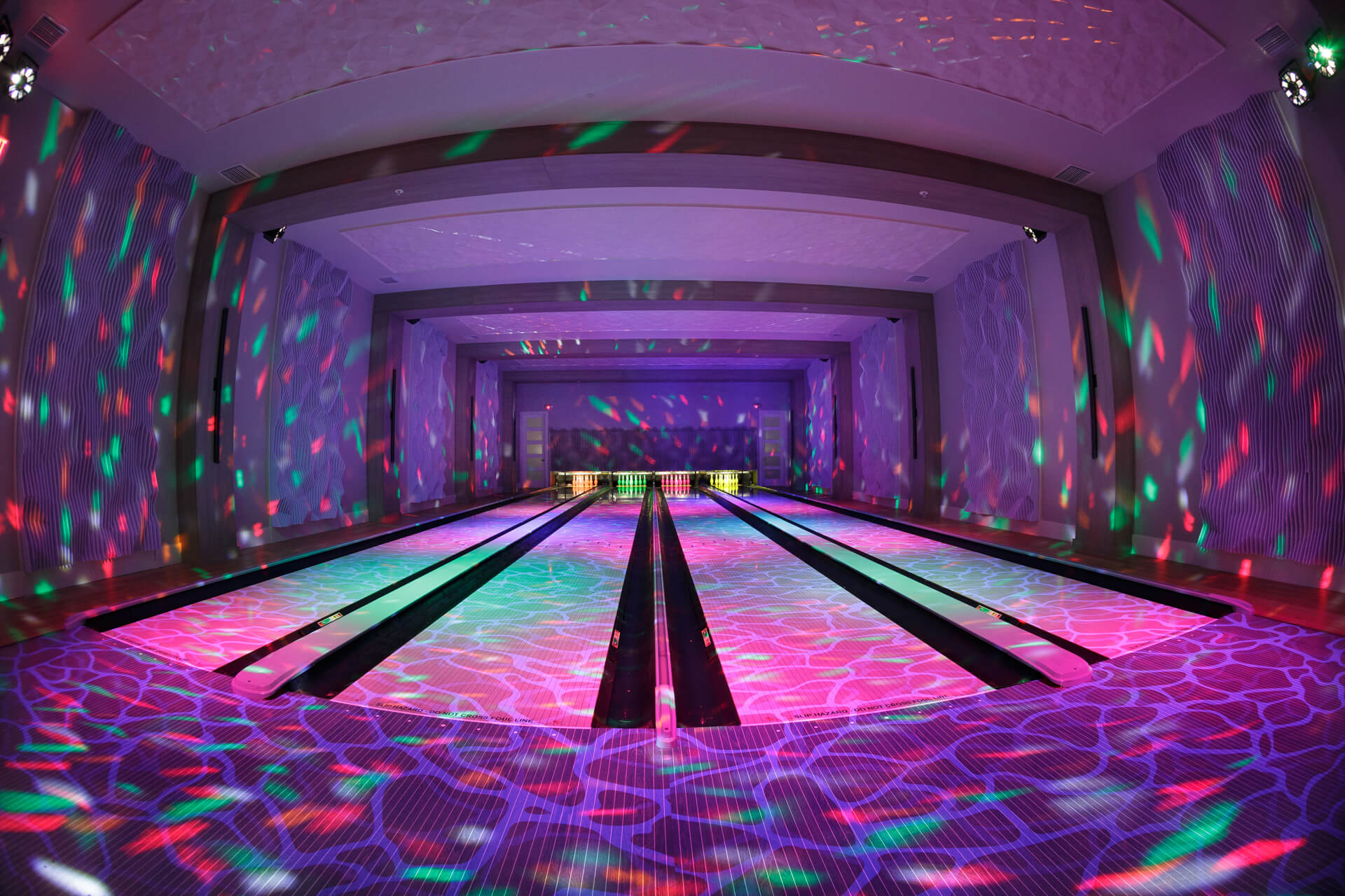 Purple glowing four-lane private bowling alley