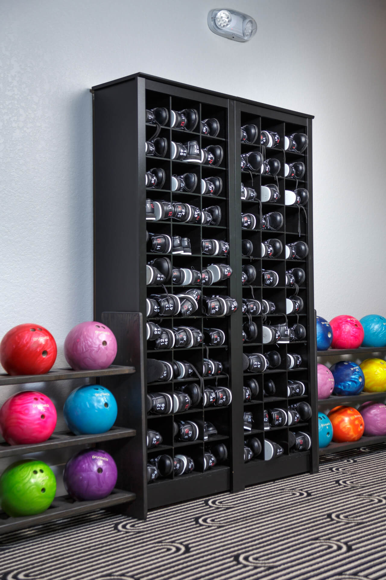 Bowling ball and bowling shoe storage racks and cubby holes.