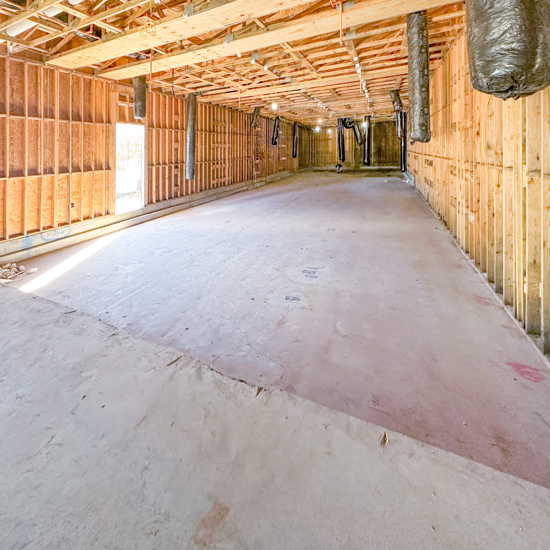 Building a bowling alley room with a sunken concrete slab floor.