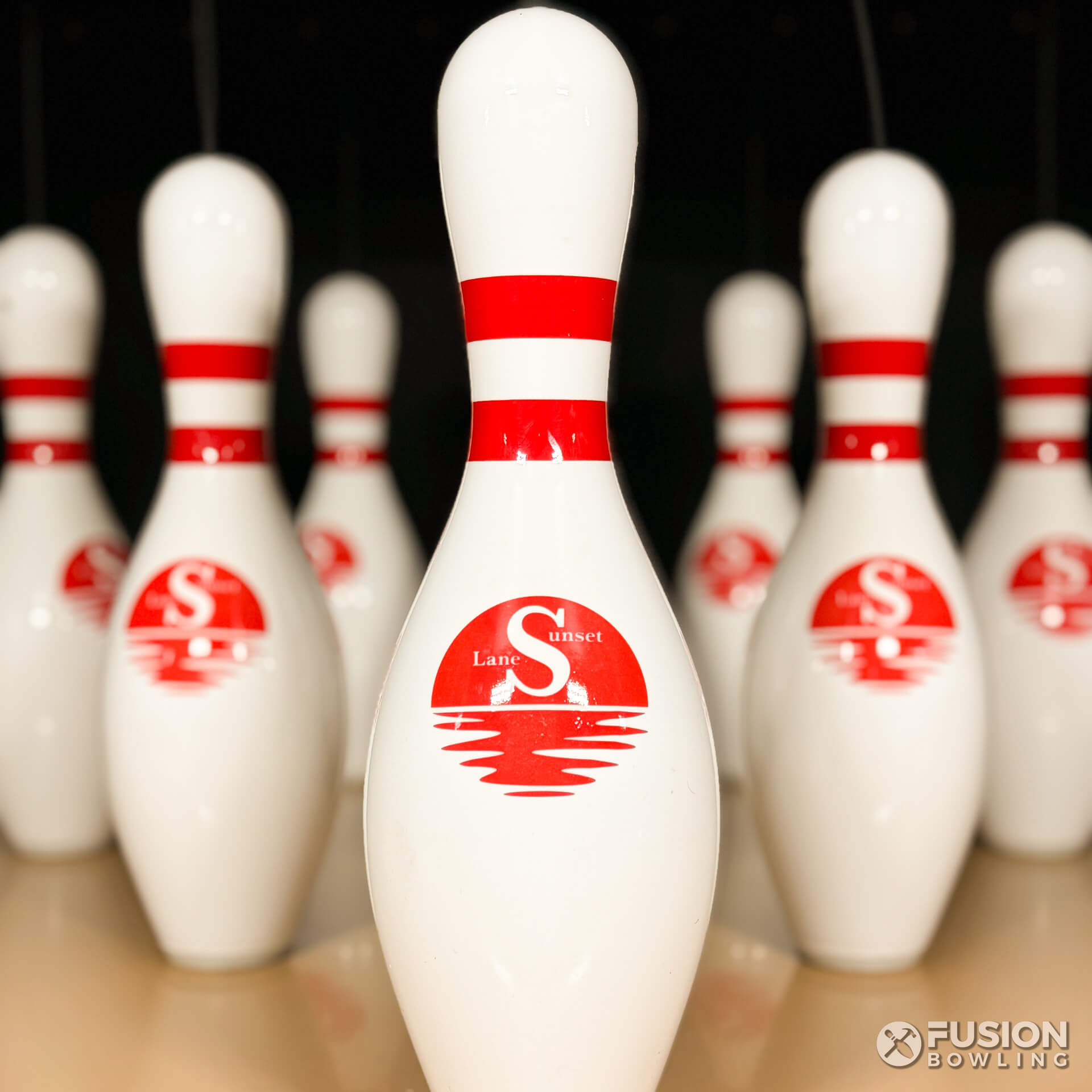 Custom bowling pins with Sunset Lane logo.