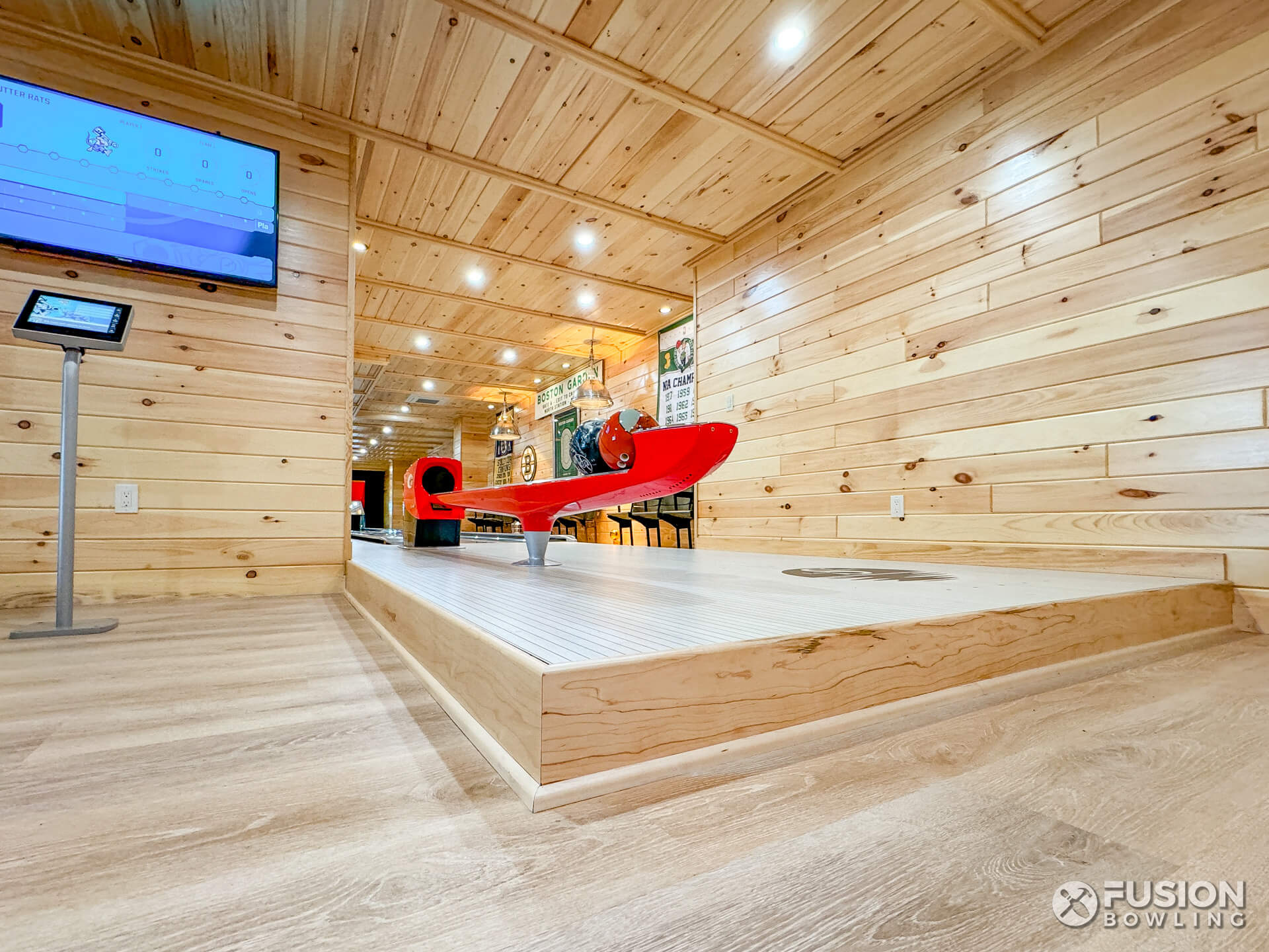 Single-lane bowling alley raised up one step above the adjacent floor.