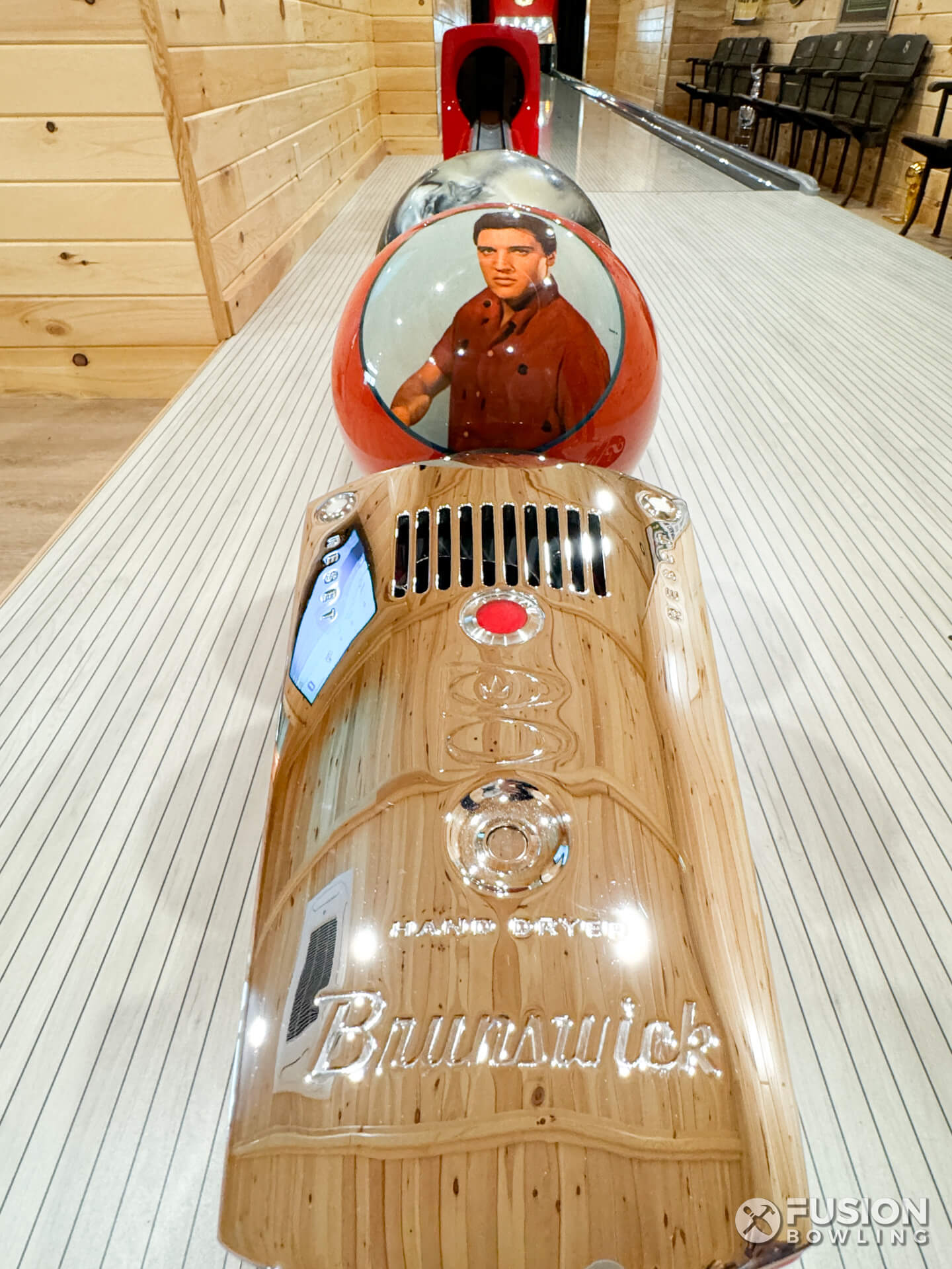 Elvis bowling ball on an old restored Brunswick ball return's in-line rack with chrome faceplate.