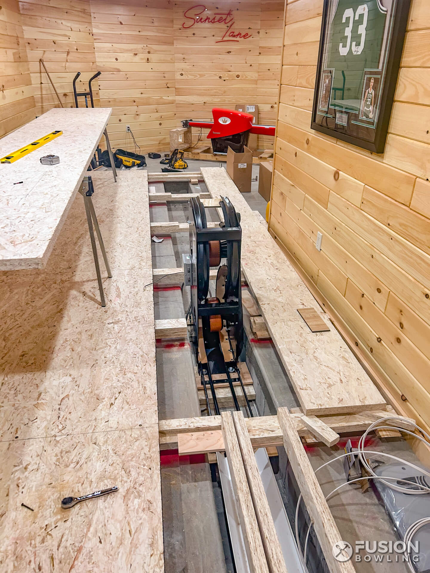 Ball return being built in a home bowling alley with a concrete slab trench.