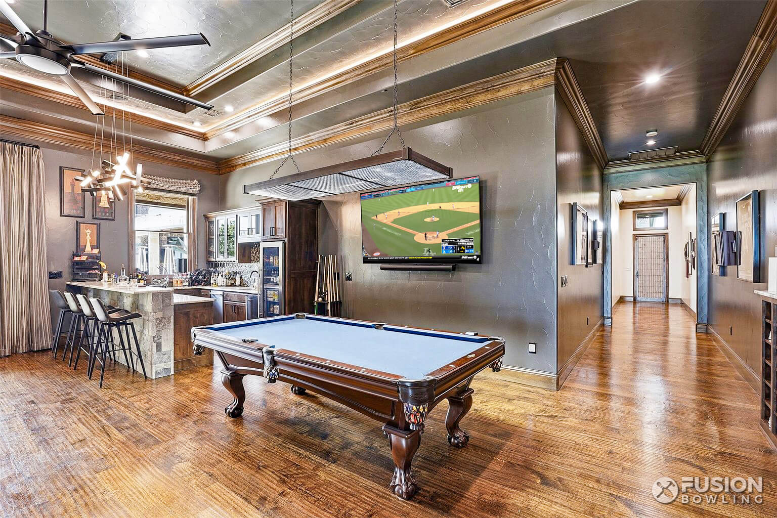 Billiards table with TV on the wall.