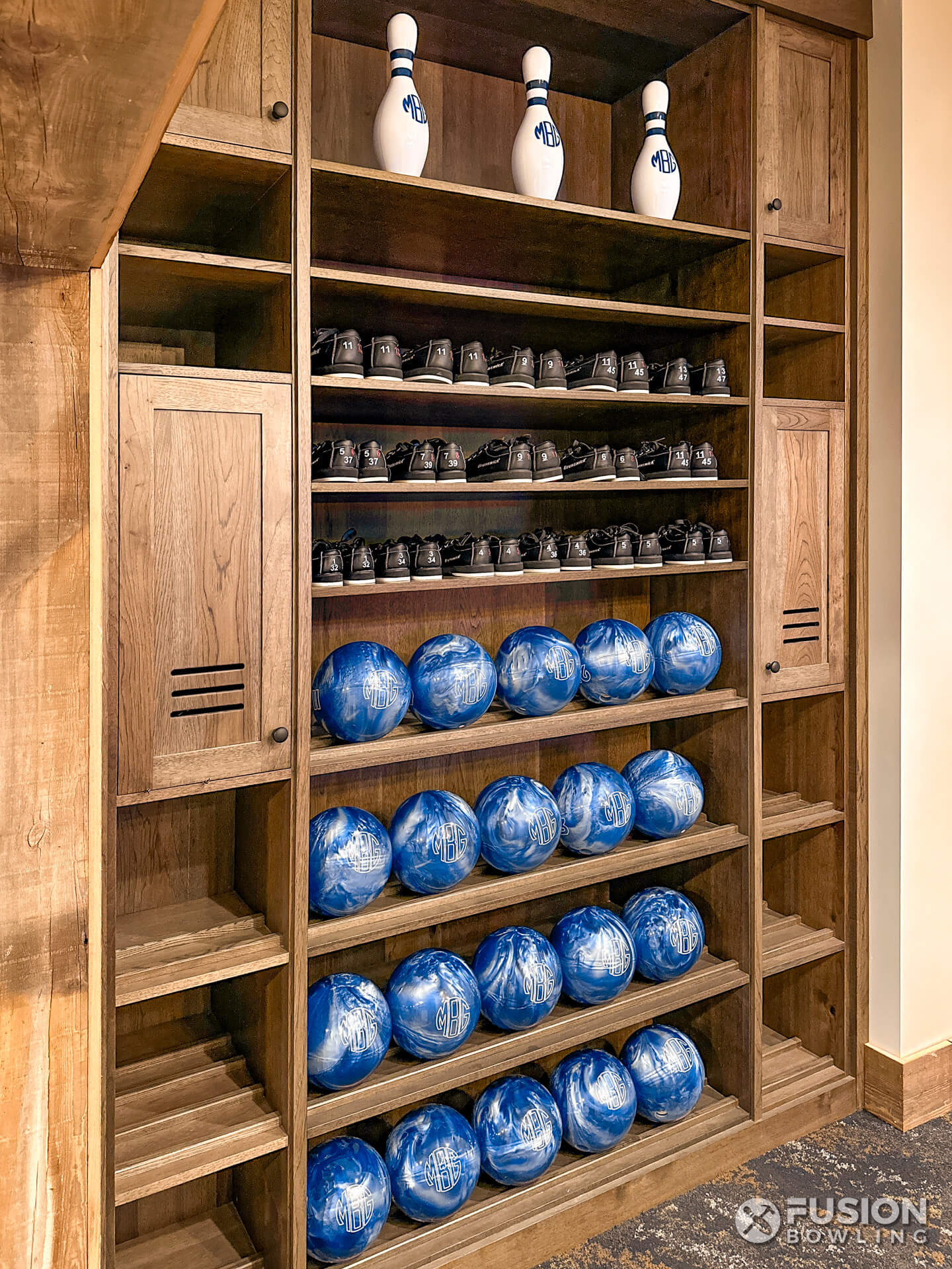 Built-in custom millwork shelving for storing bowling balls and shoes.