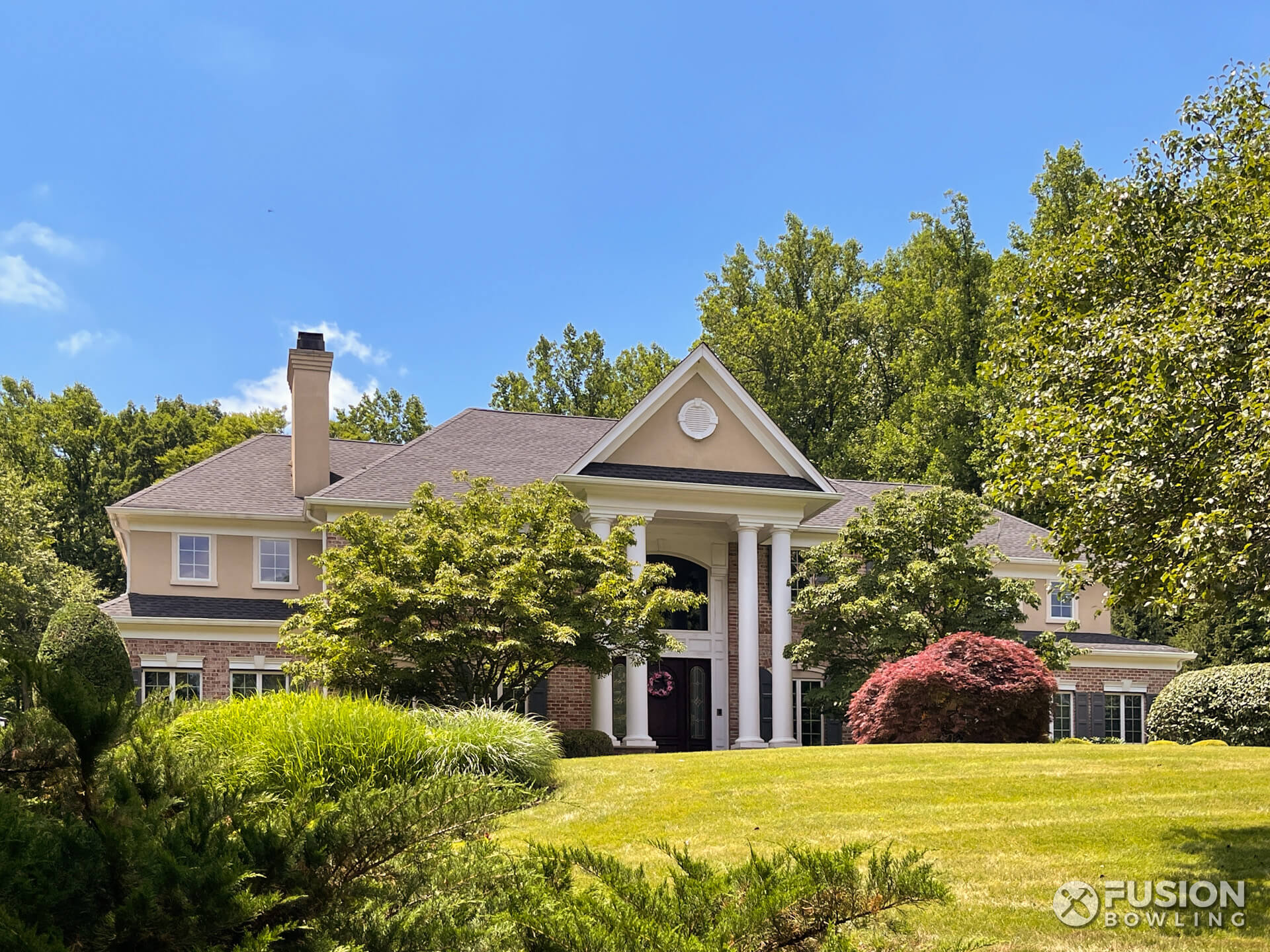 A large house with nice landscaping.
