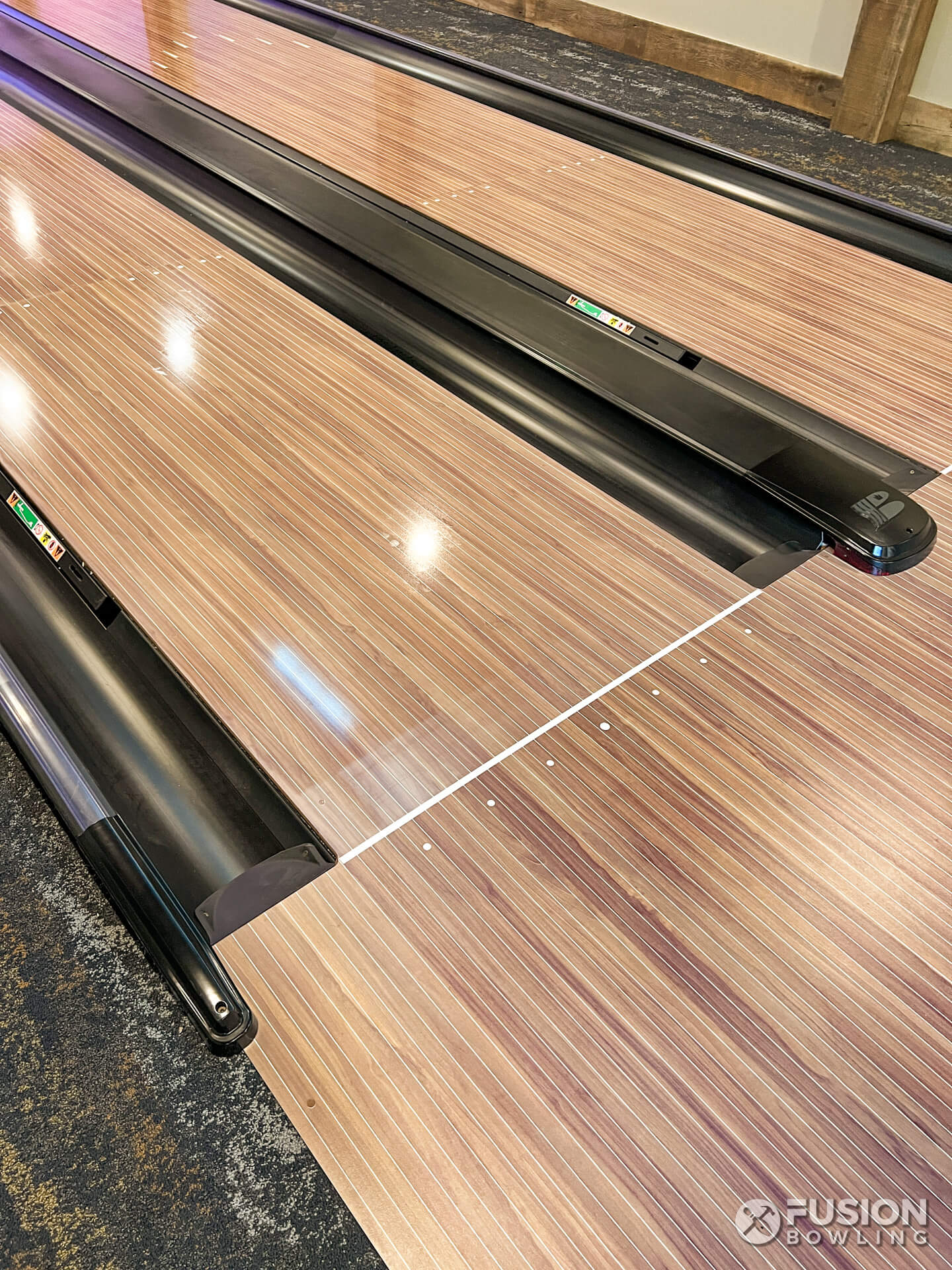 Lane oil conditioner on the bowling lanes past the foul line.