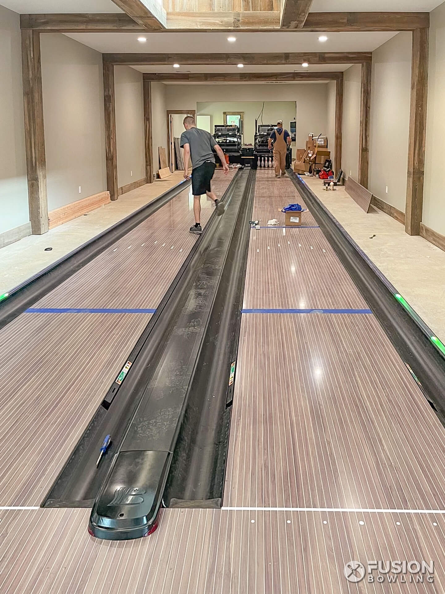 Bowling alley lane construction experts build a bowling alley in New Jersey home.