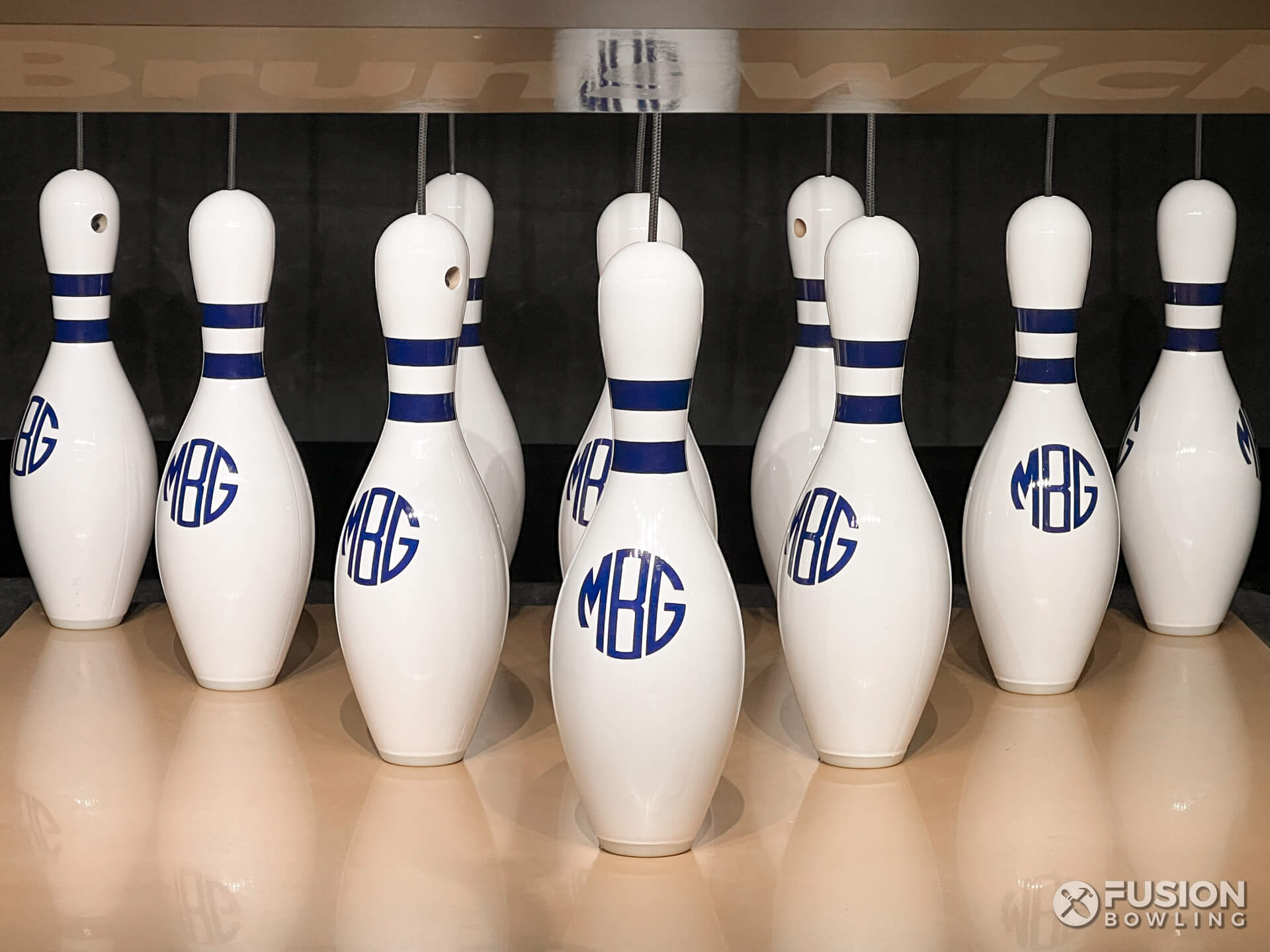 A rack of ten custom monogramed bowling pins.