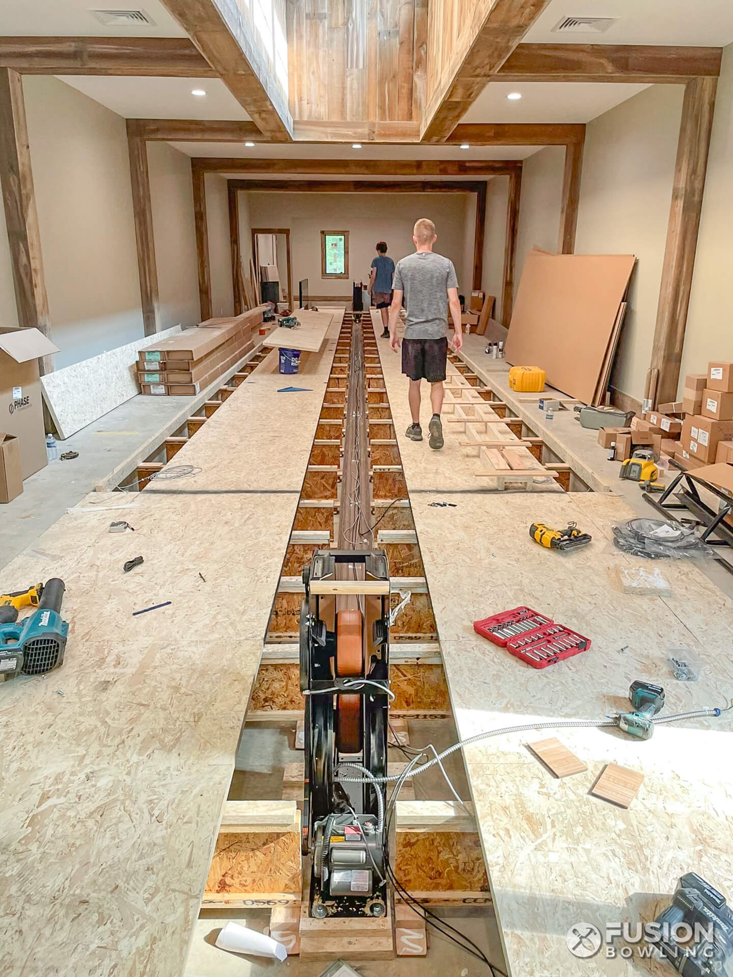Bowling lane builders work to install a private custom bowling alley in New Jersey.