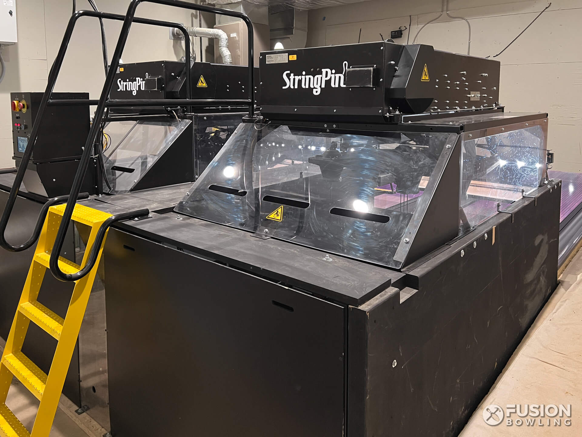 Brunswick StringPin pinsetter machines with a yellow ladder.