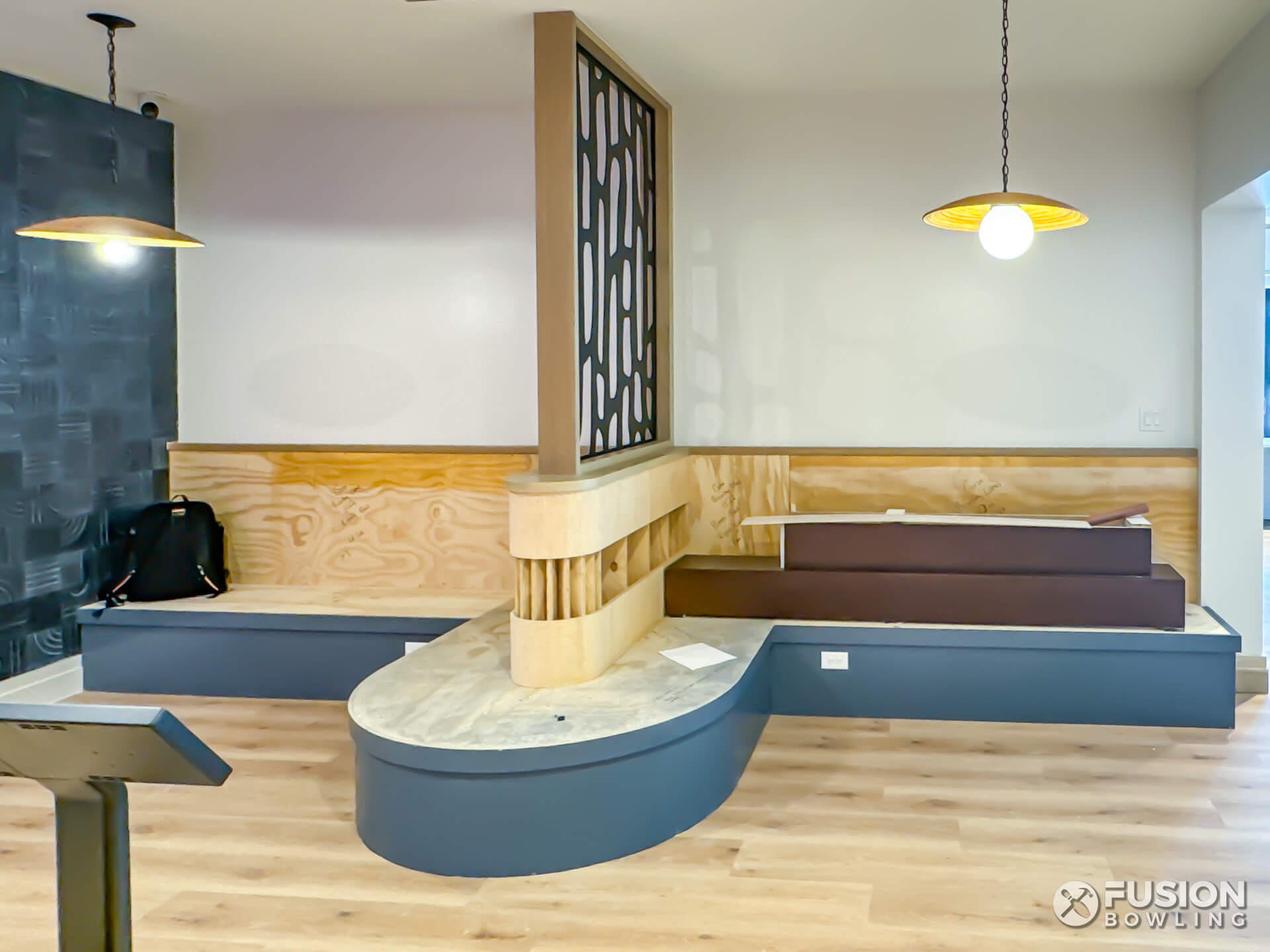 Built-in banquette seating under construction for a private bowling alley.
