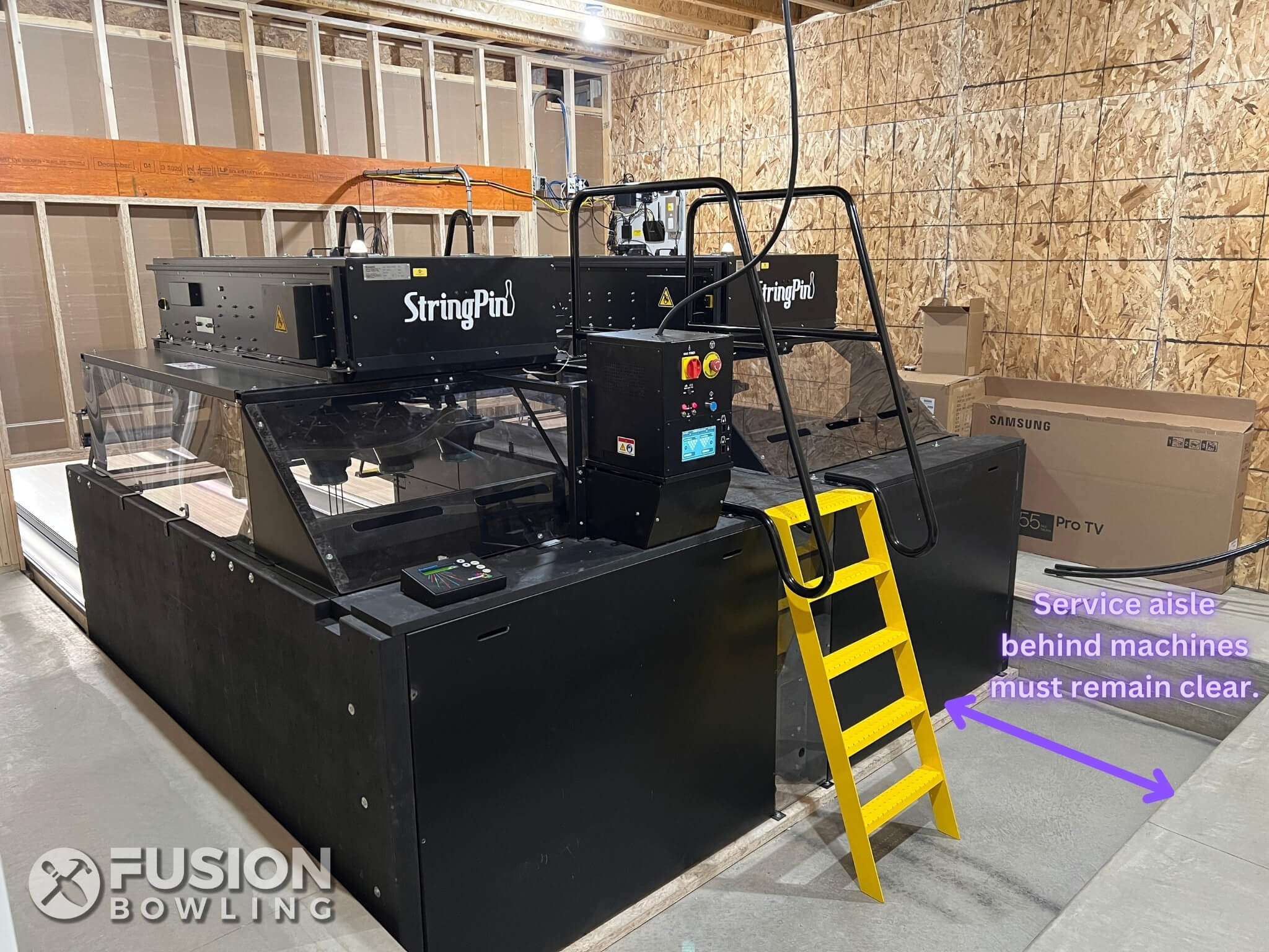 The Brunswick StringPin™ pinsetter machine (replaced by the Boost™ in 2023). Notice the service aisle behind the machines are part of the slab depression, and must remain clear.