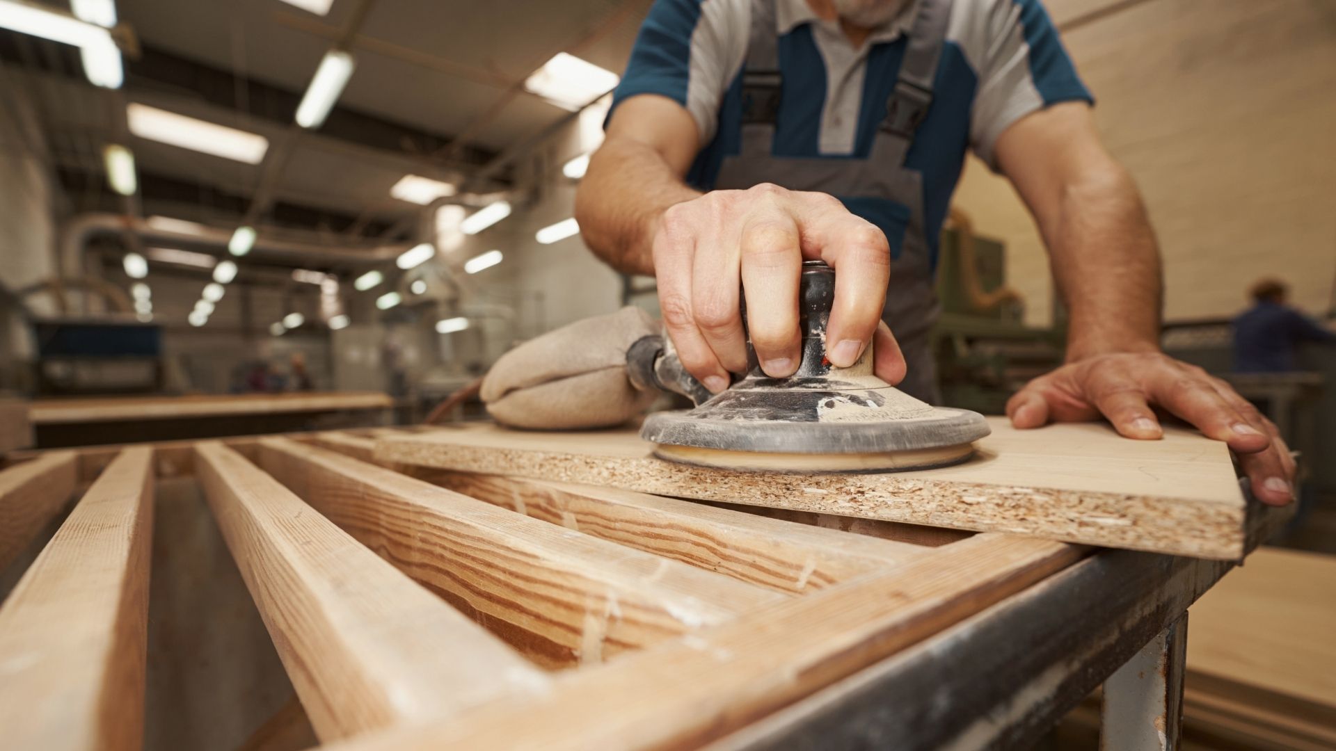 male hand grinding mdf plate
