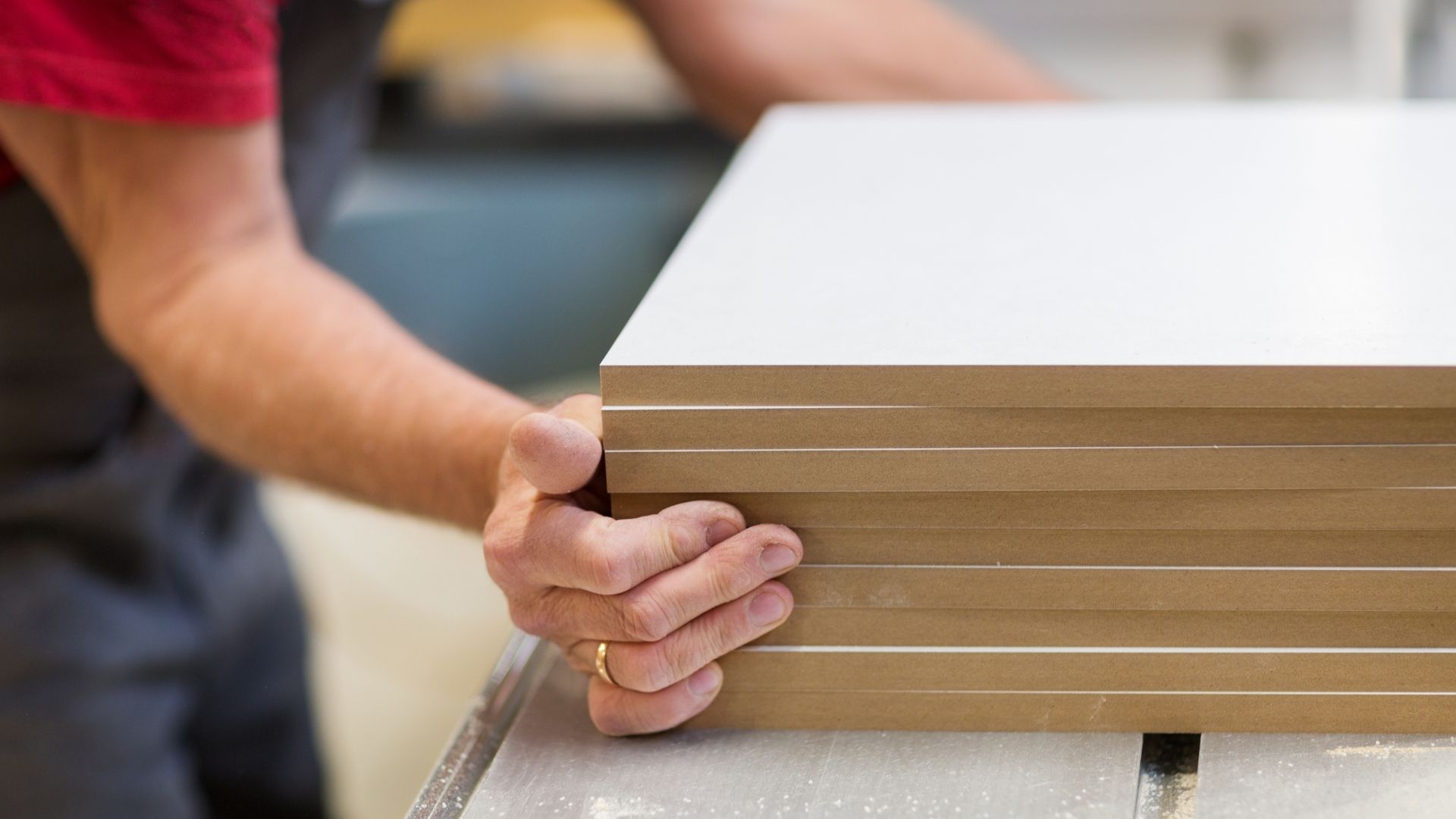 man stacking mdf boards