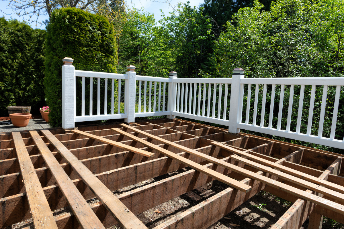Structural pine deck substructures wih white fence