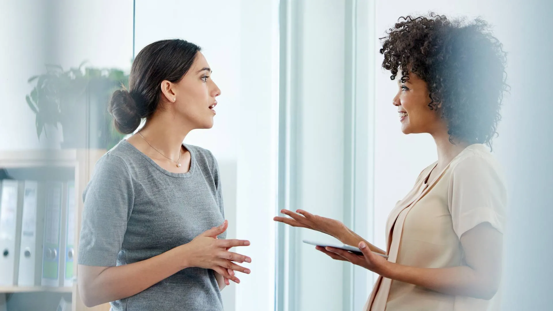 Two women are having an open and happy conversation.