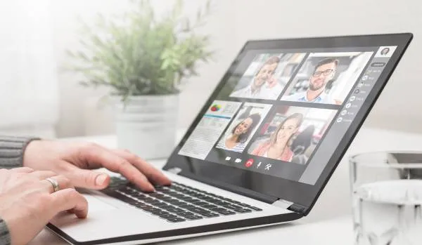 We are looking at someones laptop screen where there is a team meeting happening.
