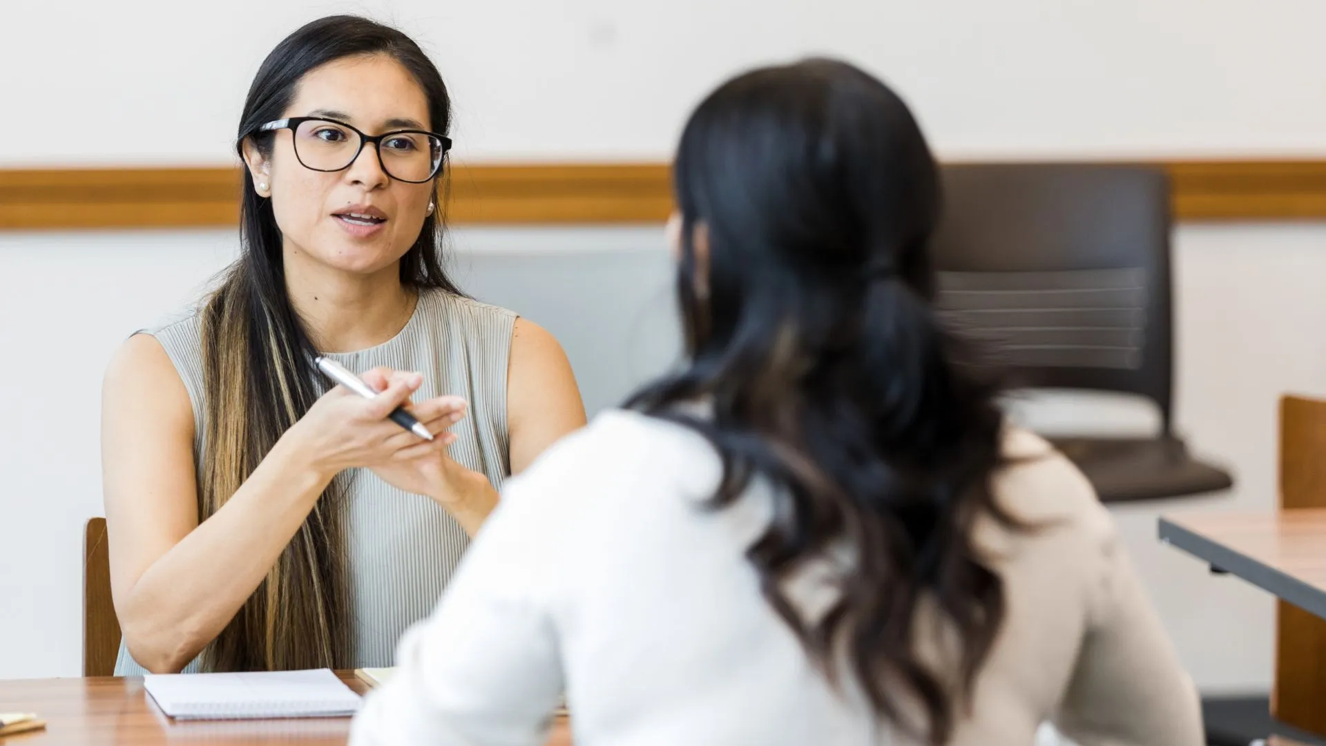 A woman is conducting a performance review with one of her team members.