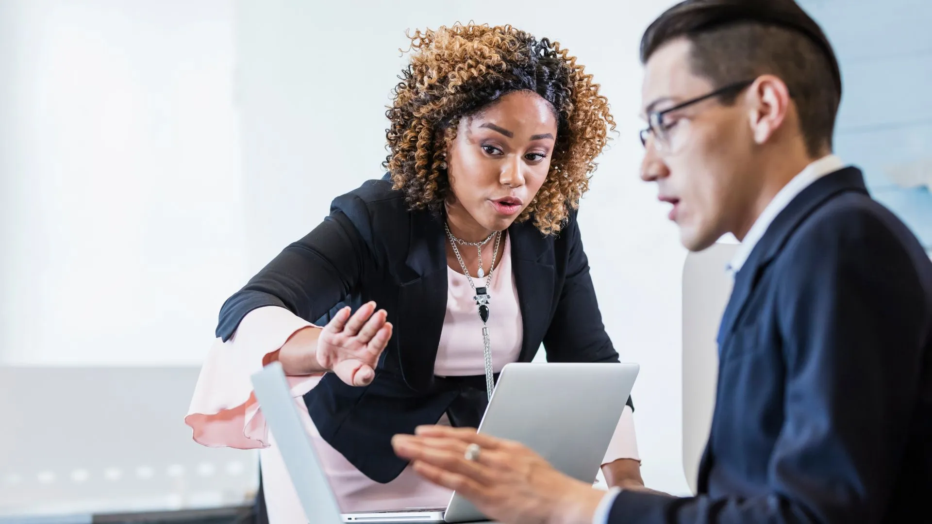 Two people are discussing business priorities in their office.