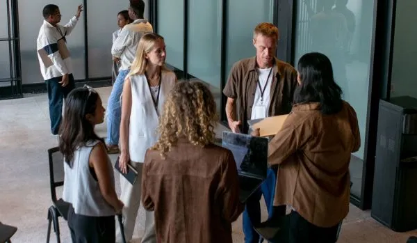 A group of people are participating in an experiential learning exercise in their office.