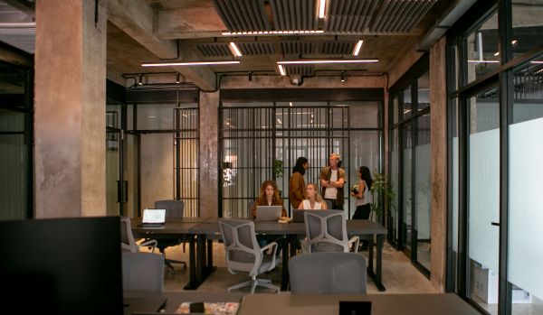 A wide view of an open office space with a team working diligently.