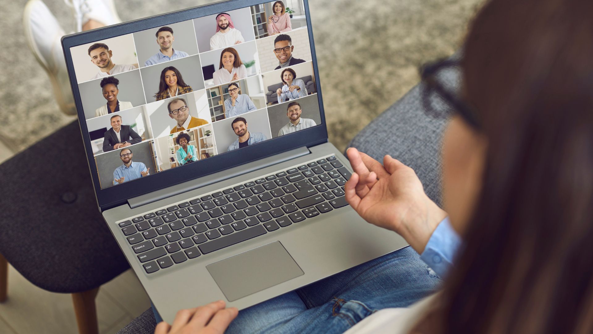 We're looking over the shoulder of a woman who is participating in a virtual training program on her laptop.