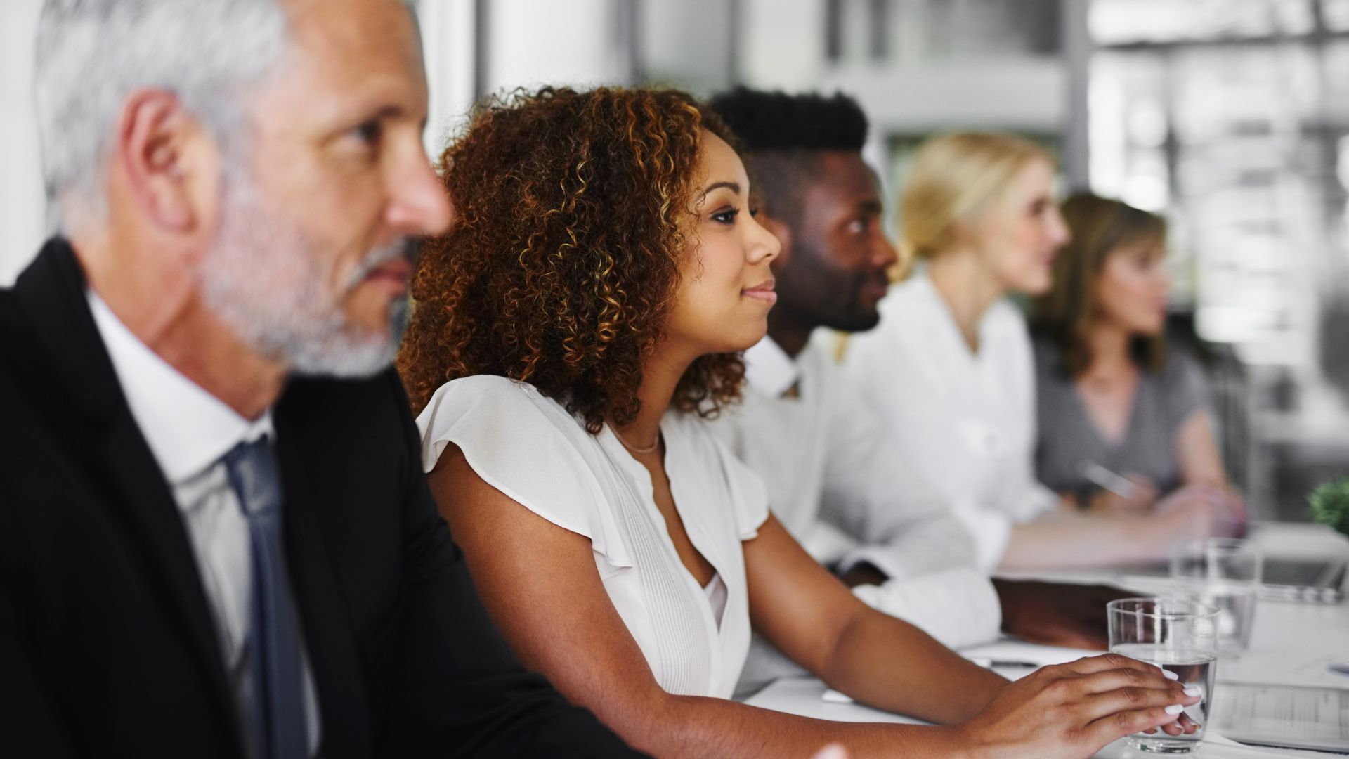 A diverse team of people are participating in a live training session.