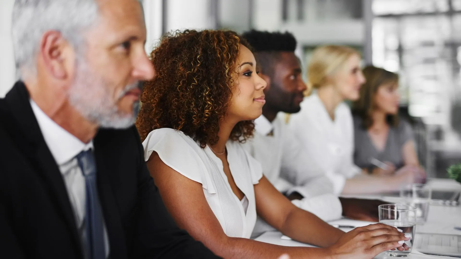 A diverse team of people are participating in a live training session.